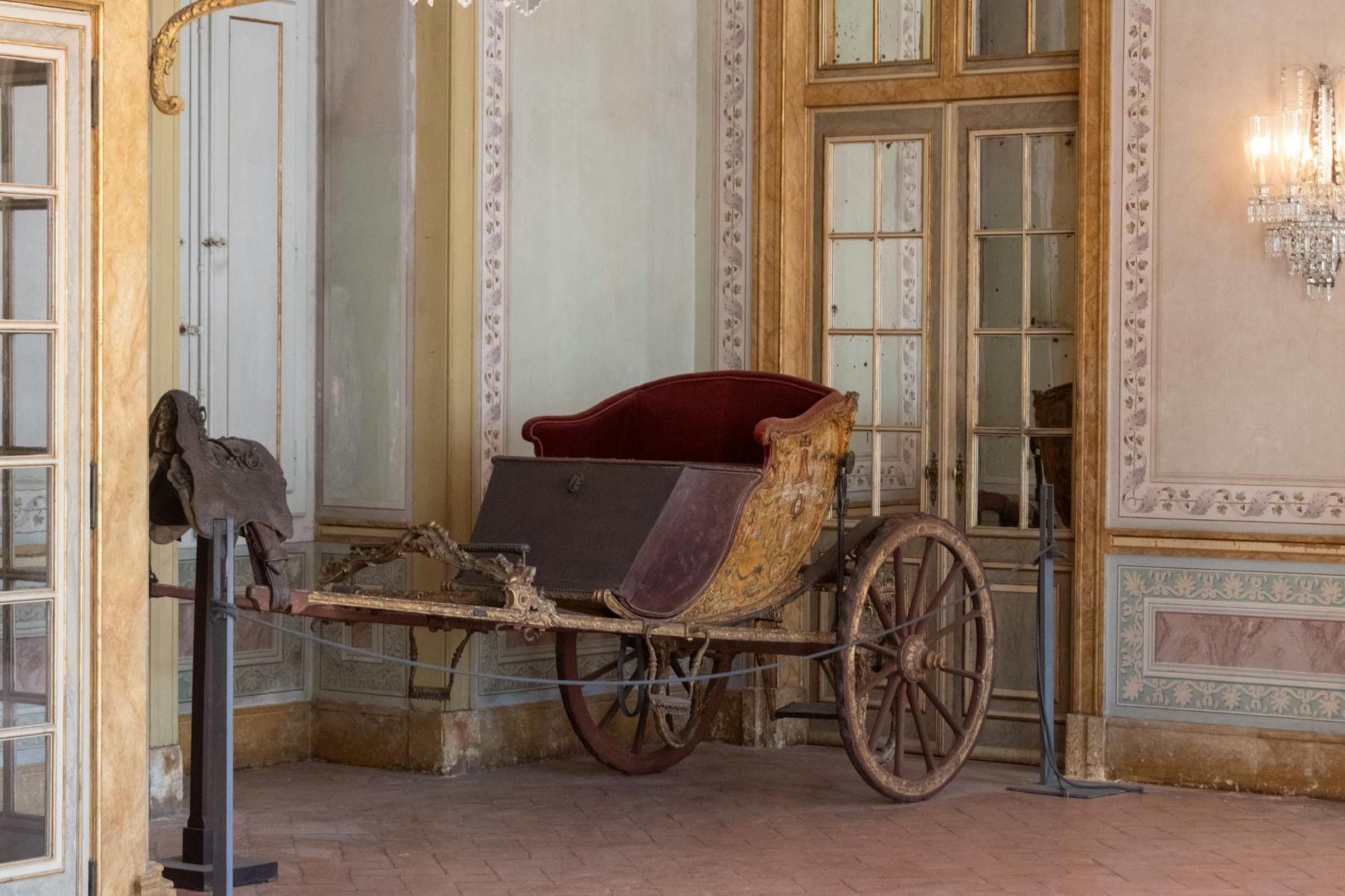Ornate gilded royal carriages at the National Coach Museum in Lisbon