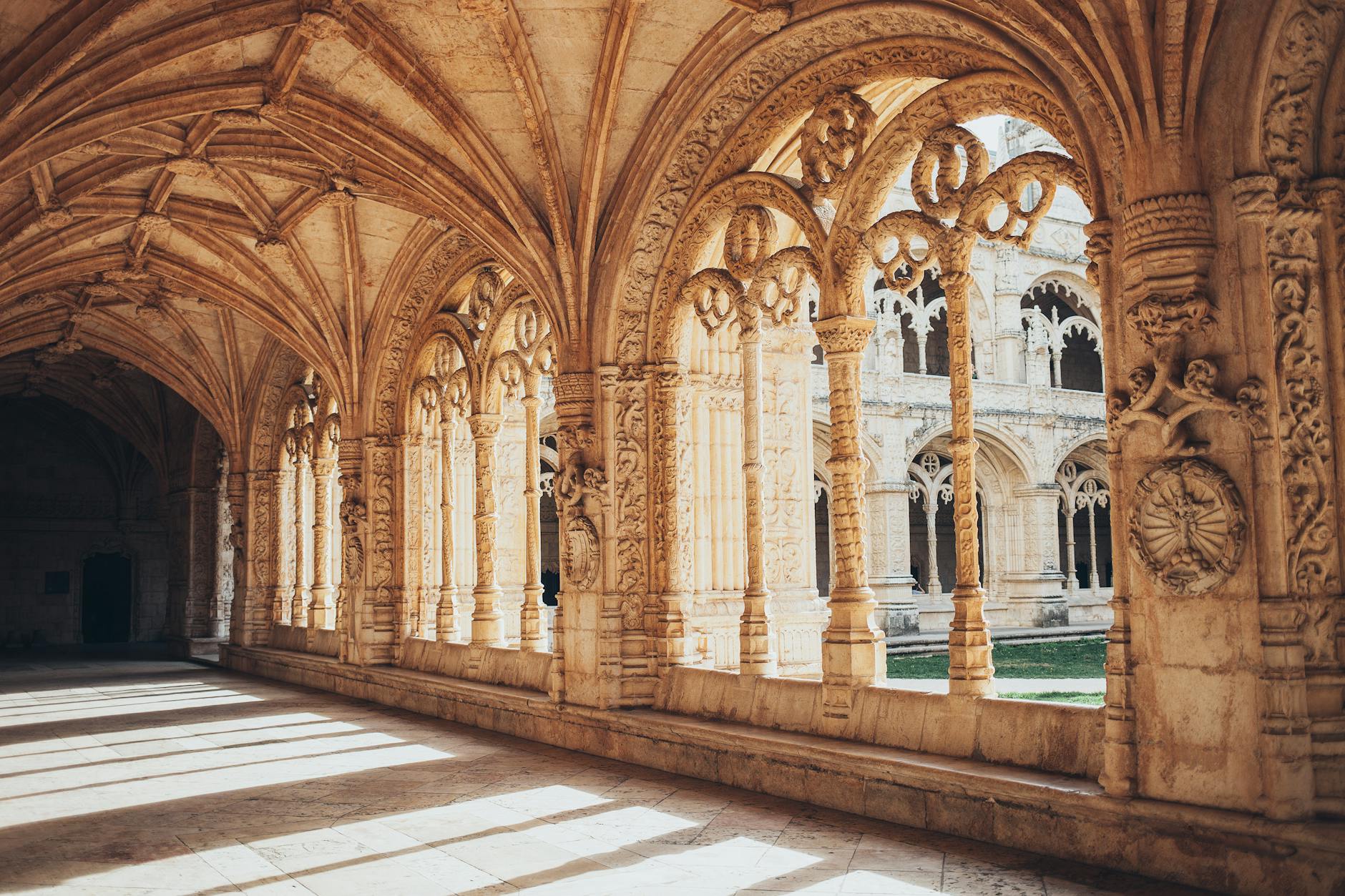 Two-story Manueline cloister of Jerónimos Monastery with carved limestone arches and columns