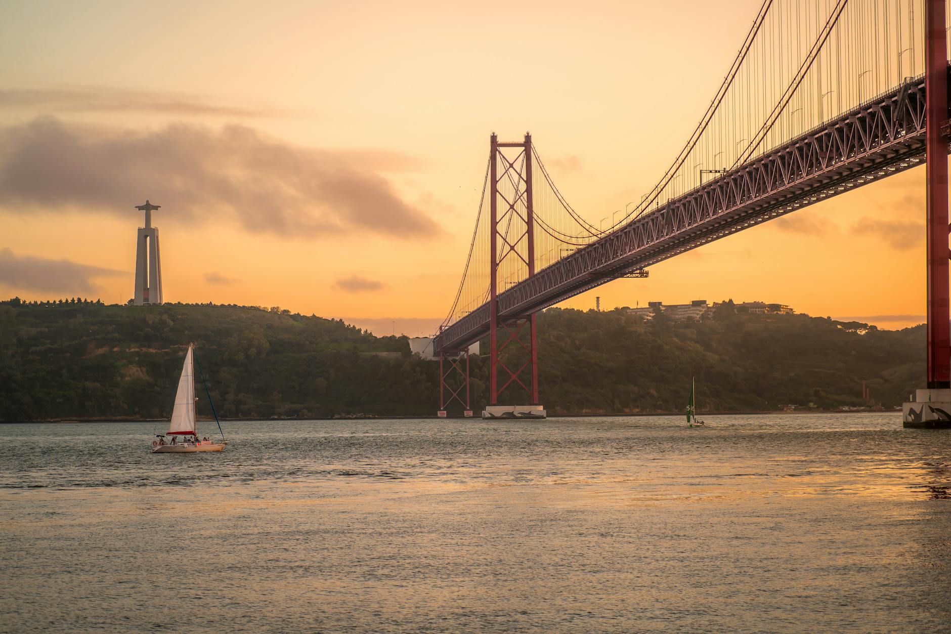 Sailboat on the Tagus River at sunset with Lisbon skyline in background