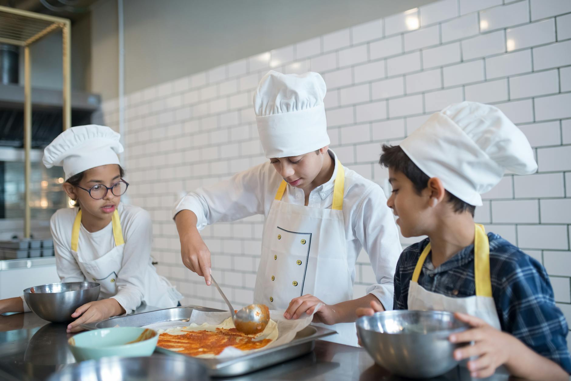 Cooking class participants preparing Portuguese food at a wooden countertop