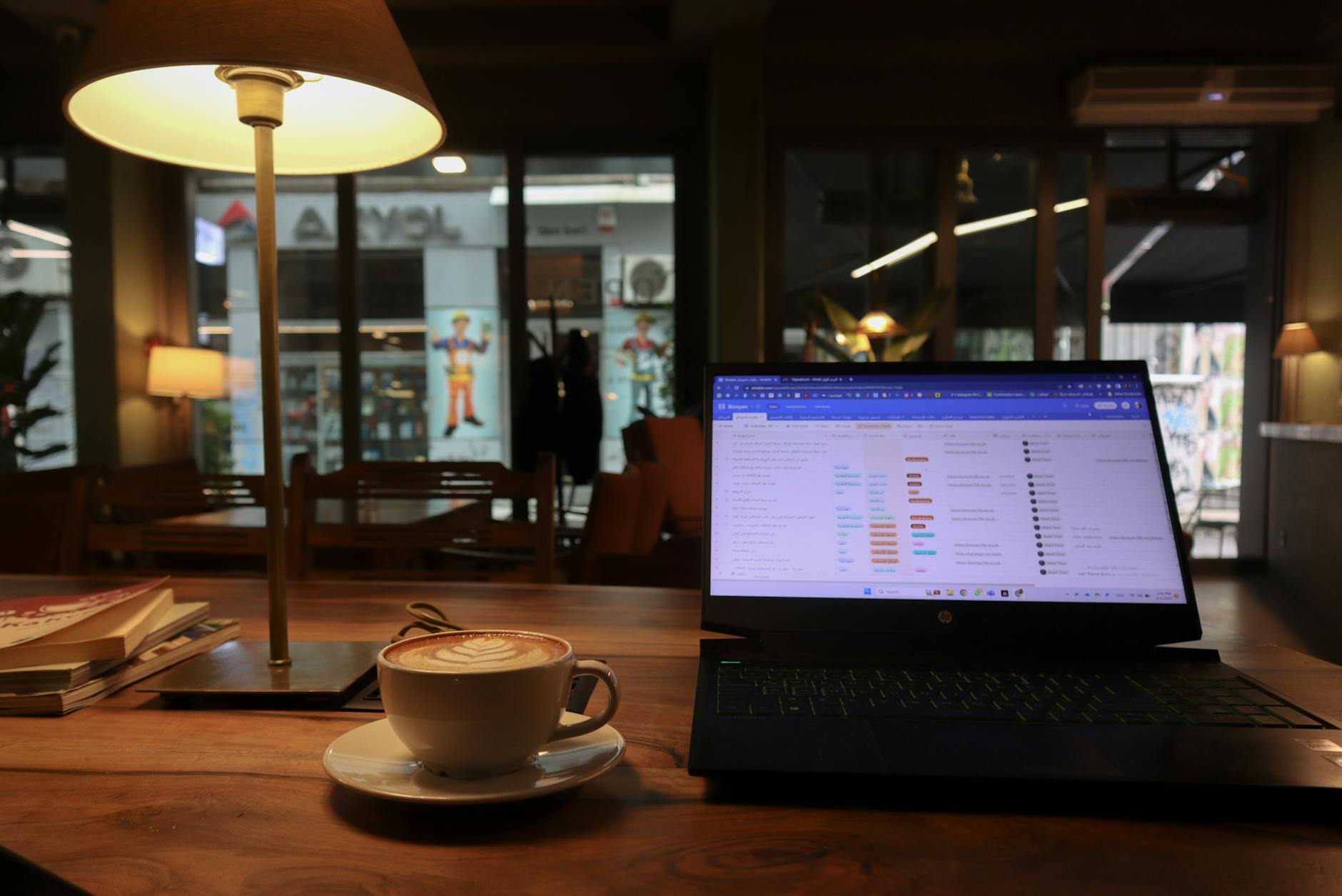 Digital nomad working on laptop at a Lisbon café with traditional tile walls