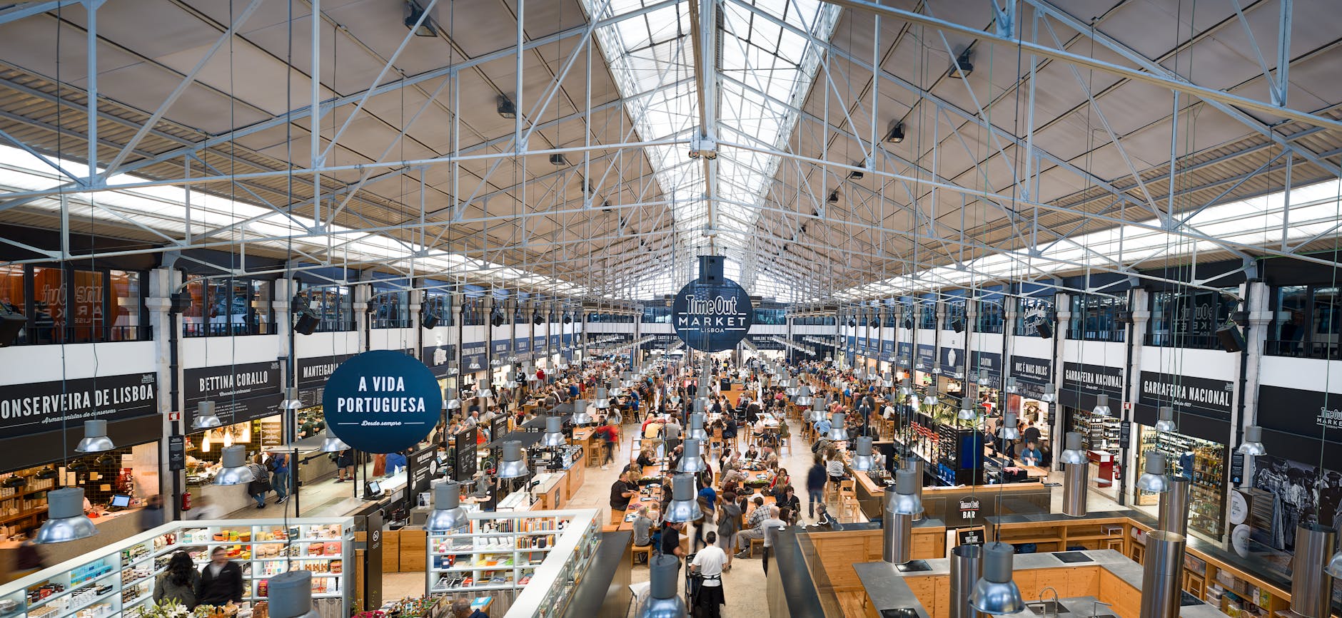 Lisbon food market with fresh produce cheese and cured meats stalls