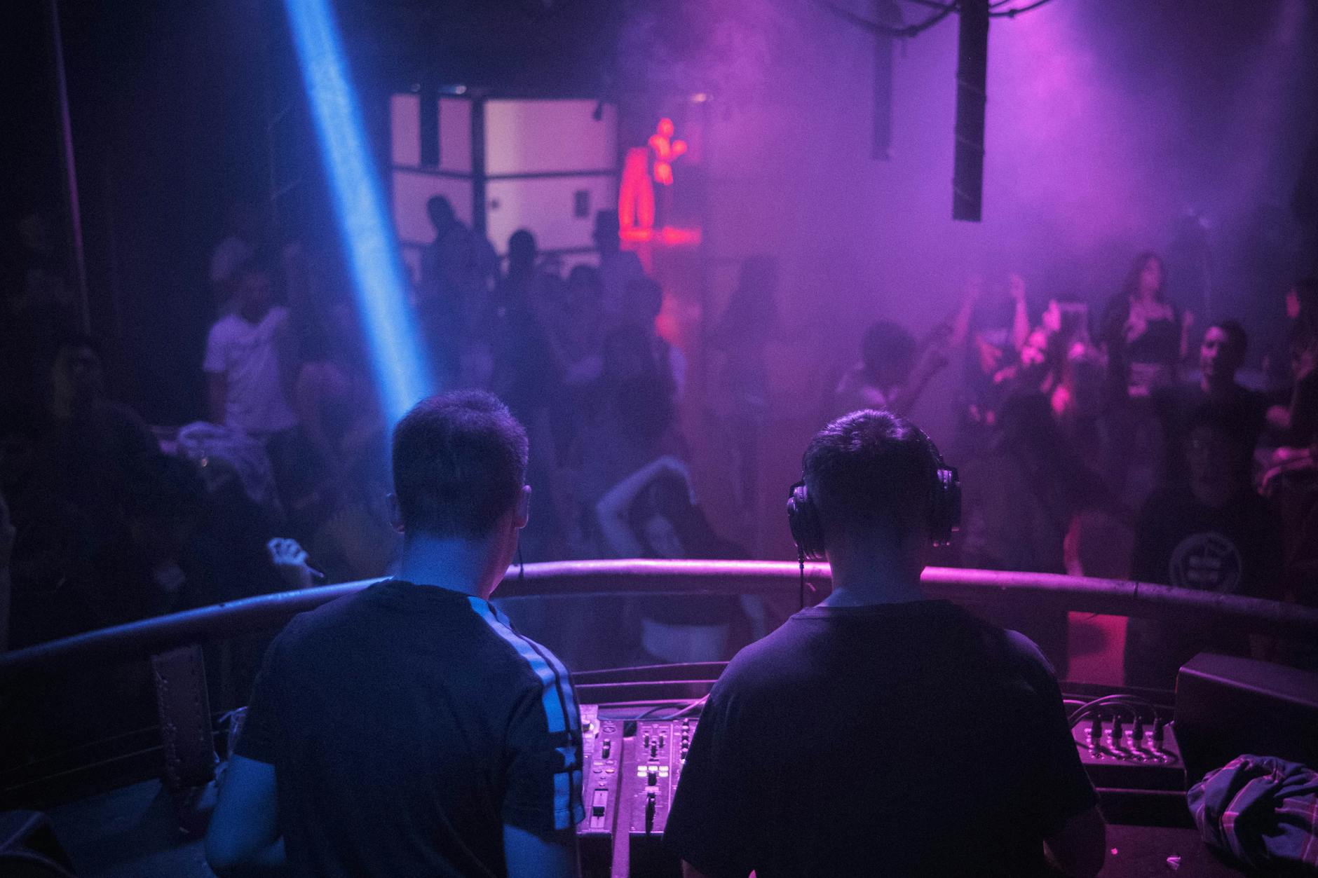 Lisbon nightclub with neon lights and crowd dancing on a packed dance floor