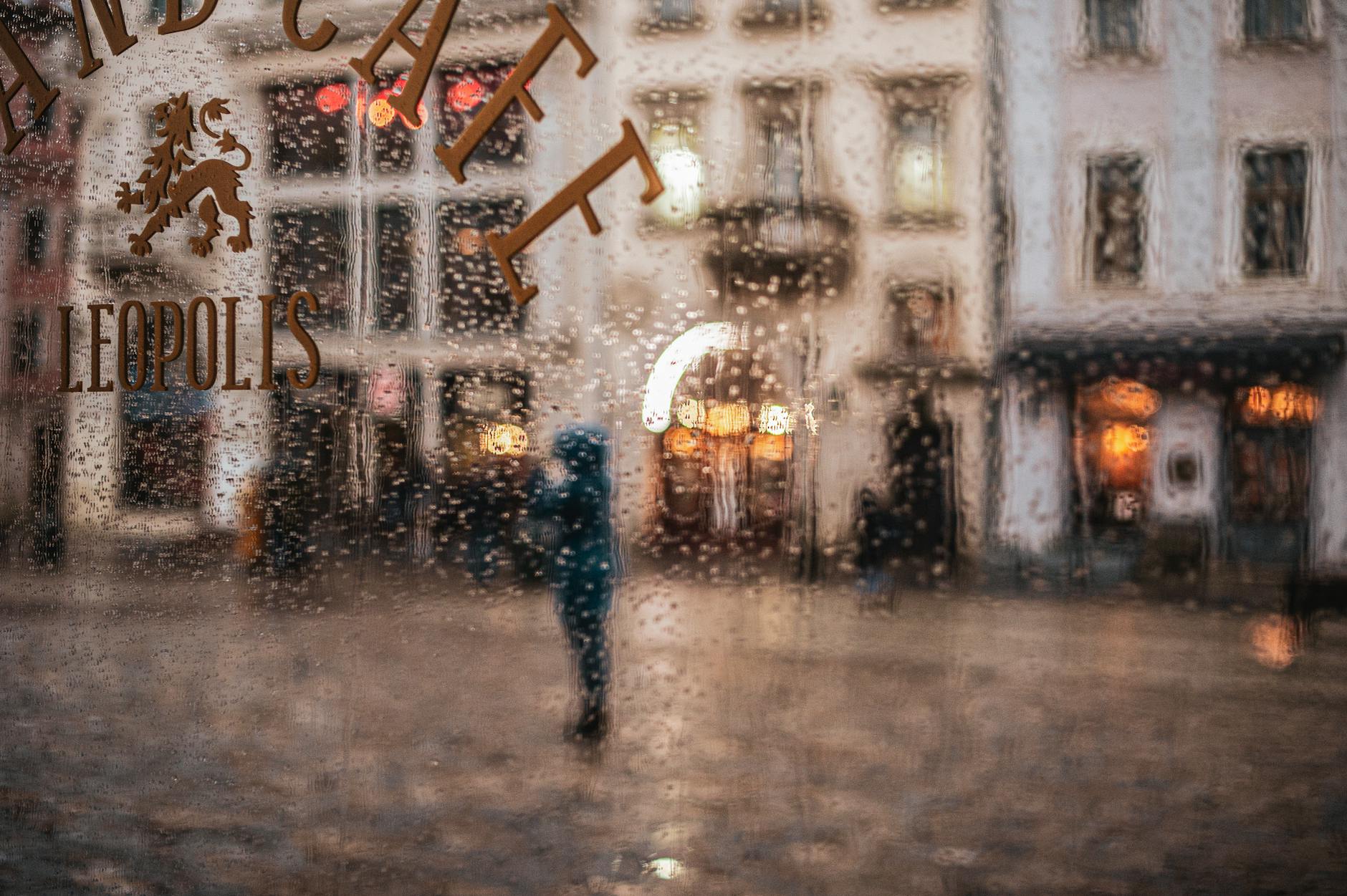 Cozy historic Lisbon café with people enjoying coffee while rain falls outside
