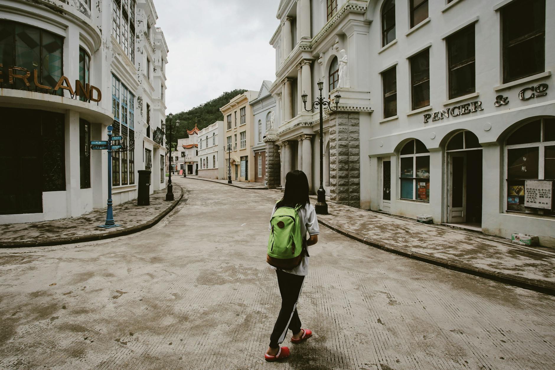Solo female traveler photographing the colorful tile facades in Lisbon's Alfama district