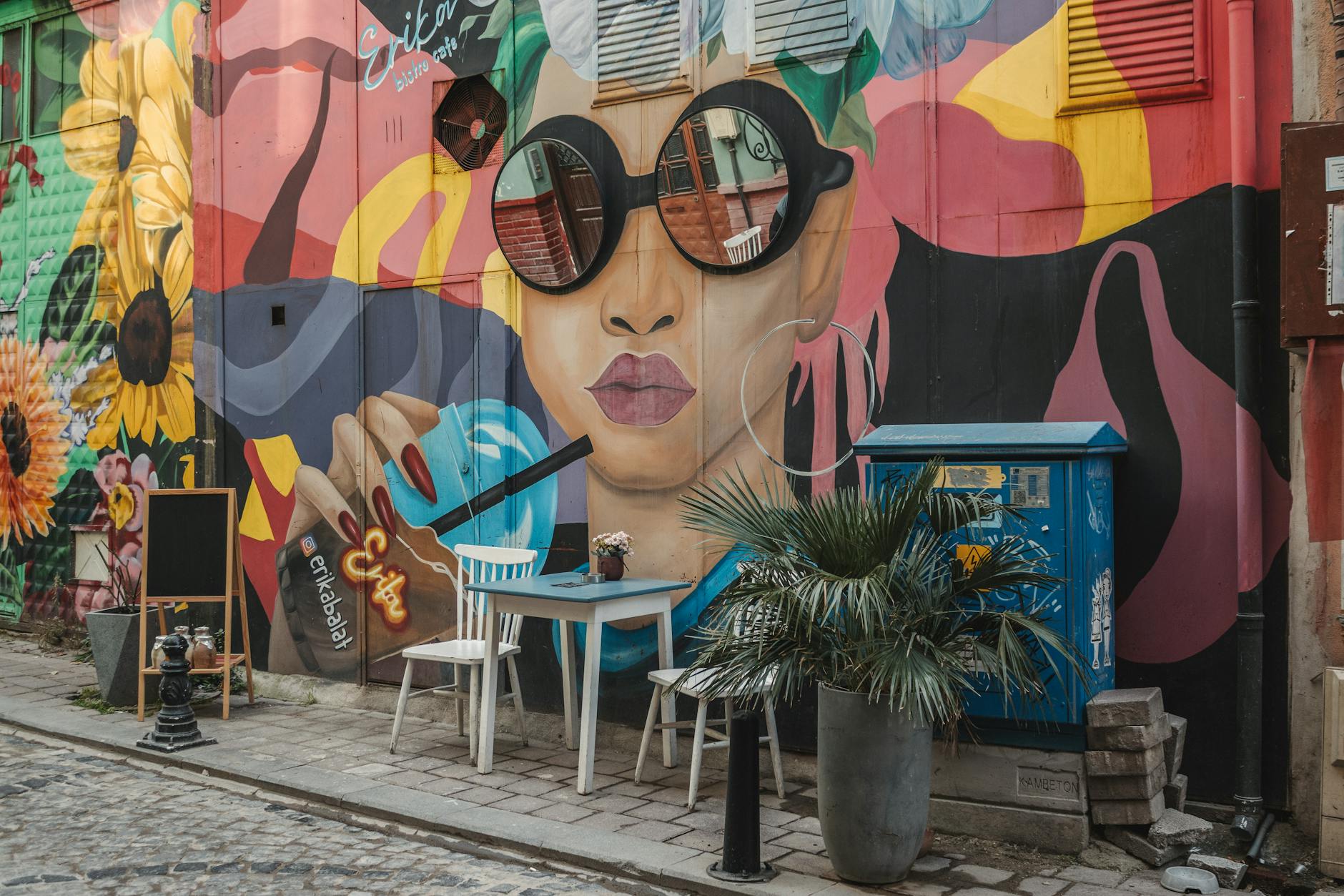 Massive colorful raccoon mural made of recycled trash by Bordalo II on a Lisbon building wall