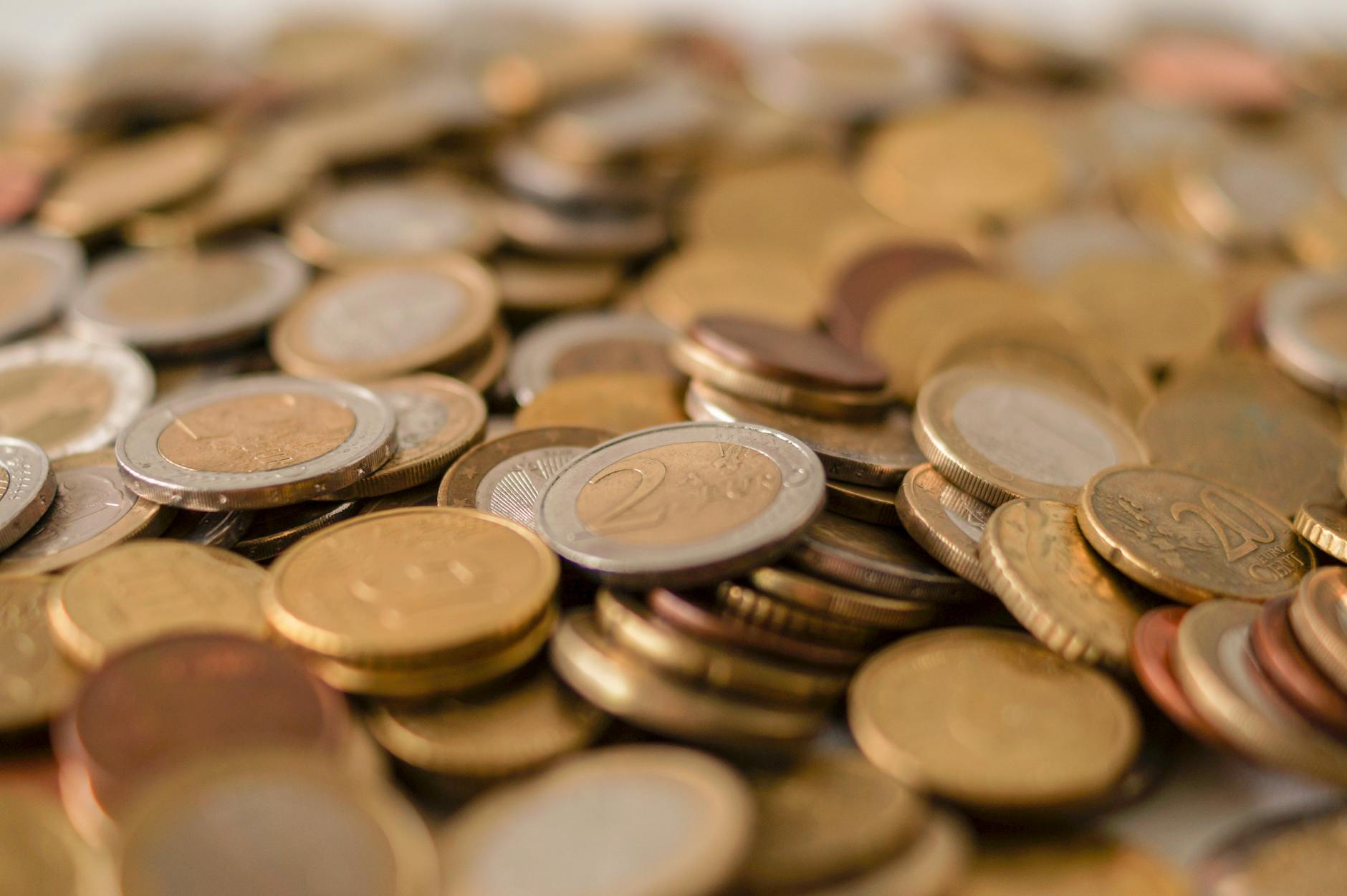 Euro coins and banknotes on a Lisbon café table with coffee cup
