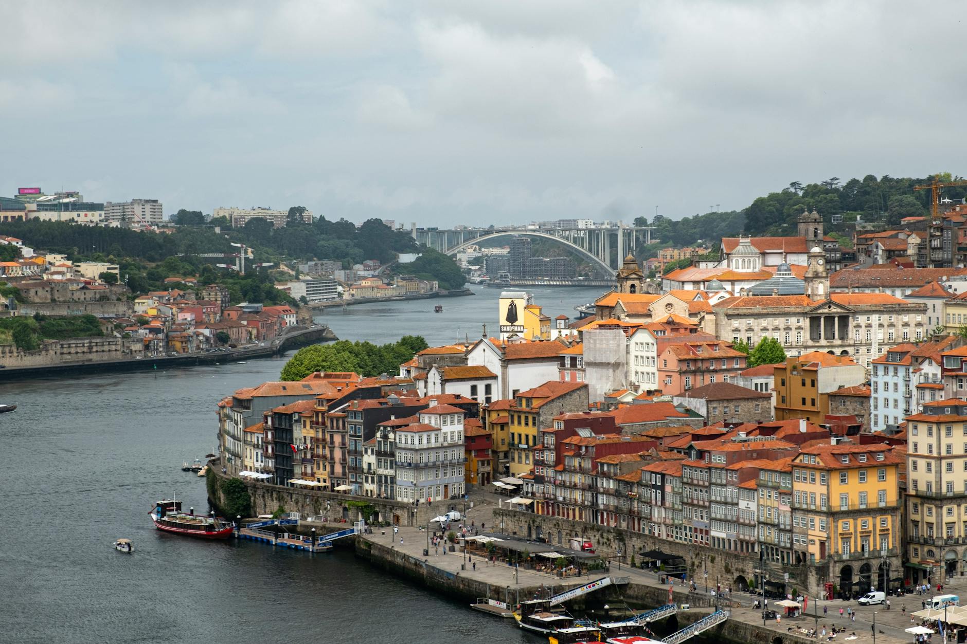 Split image comparing Lisbon's hilly tile-decorated buildings with Porto's red-tiled rooftops along the Douro River
