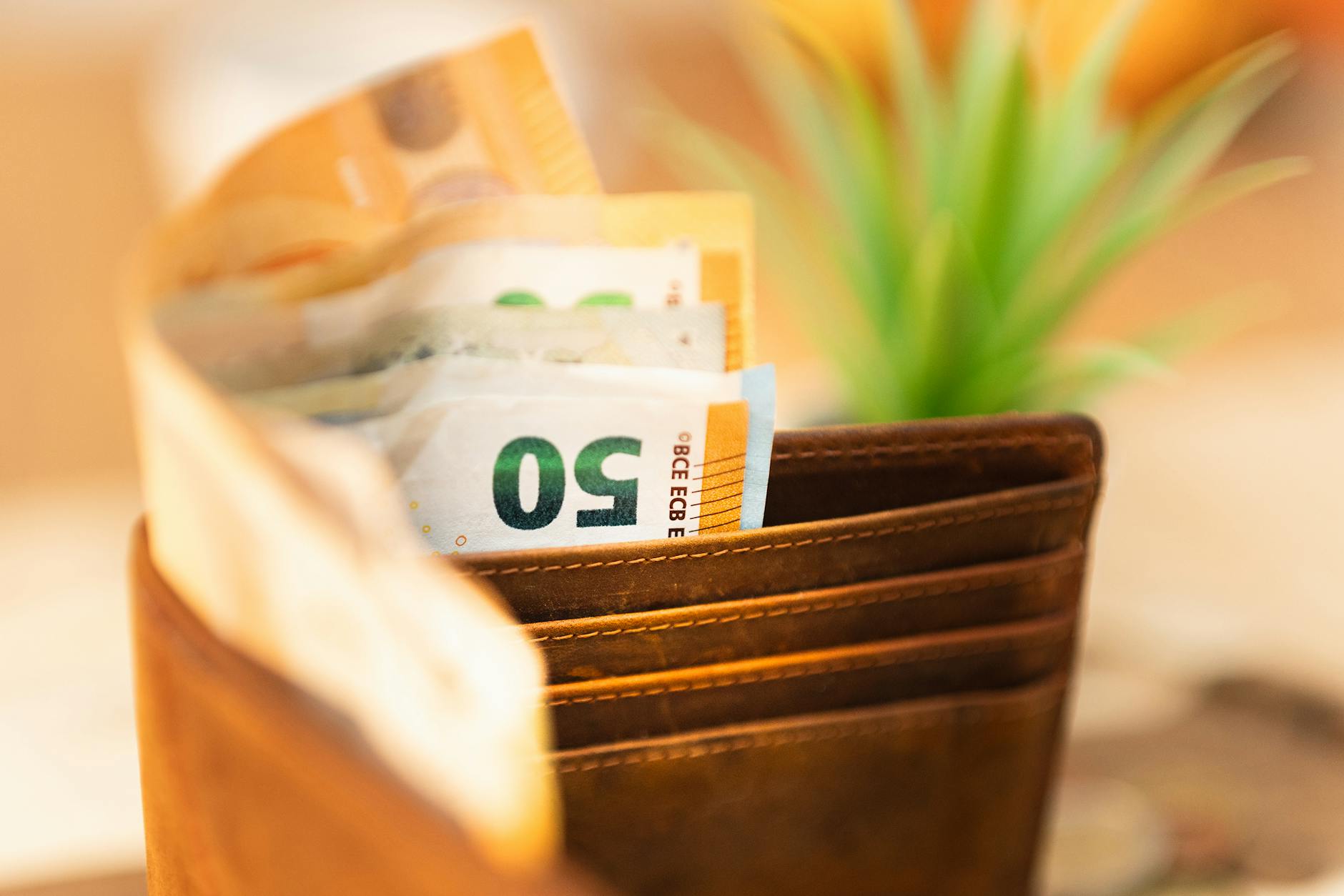 Euro banknotes and coins on a table with a Lisbon café receipt
