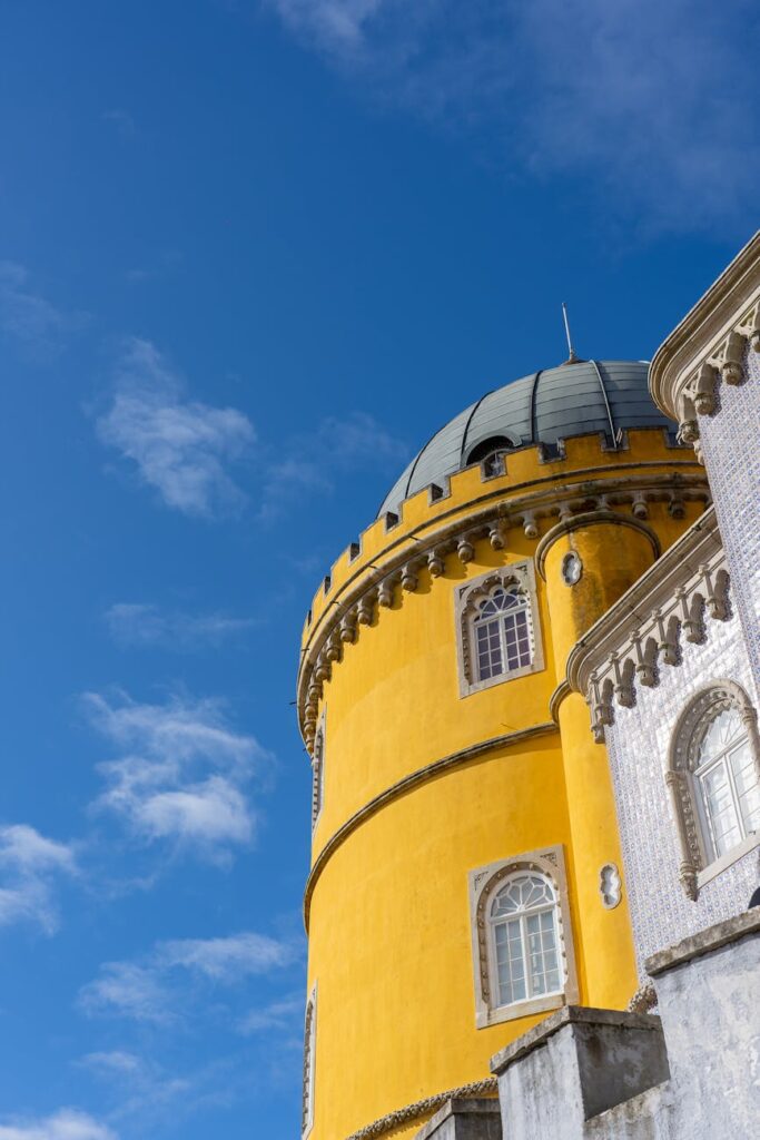 Colorful yellow and white domed architecture of Pena Palace in Sintra, a popular day trip from Lisbon