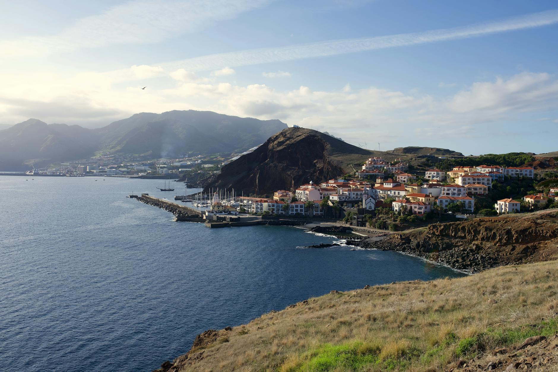 View of Sesimbra fishing village with sheltered bay and clifftop castle in Portugal