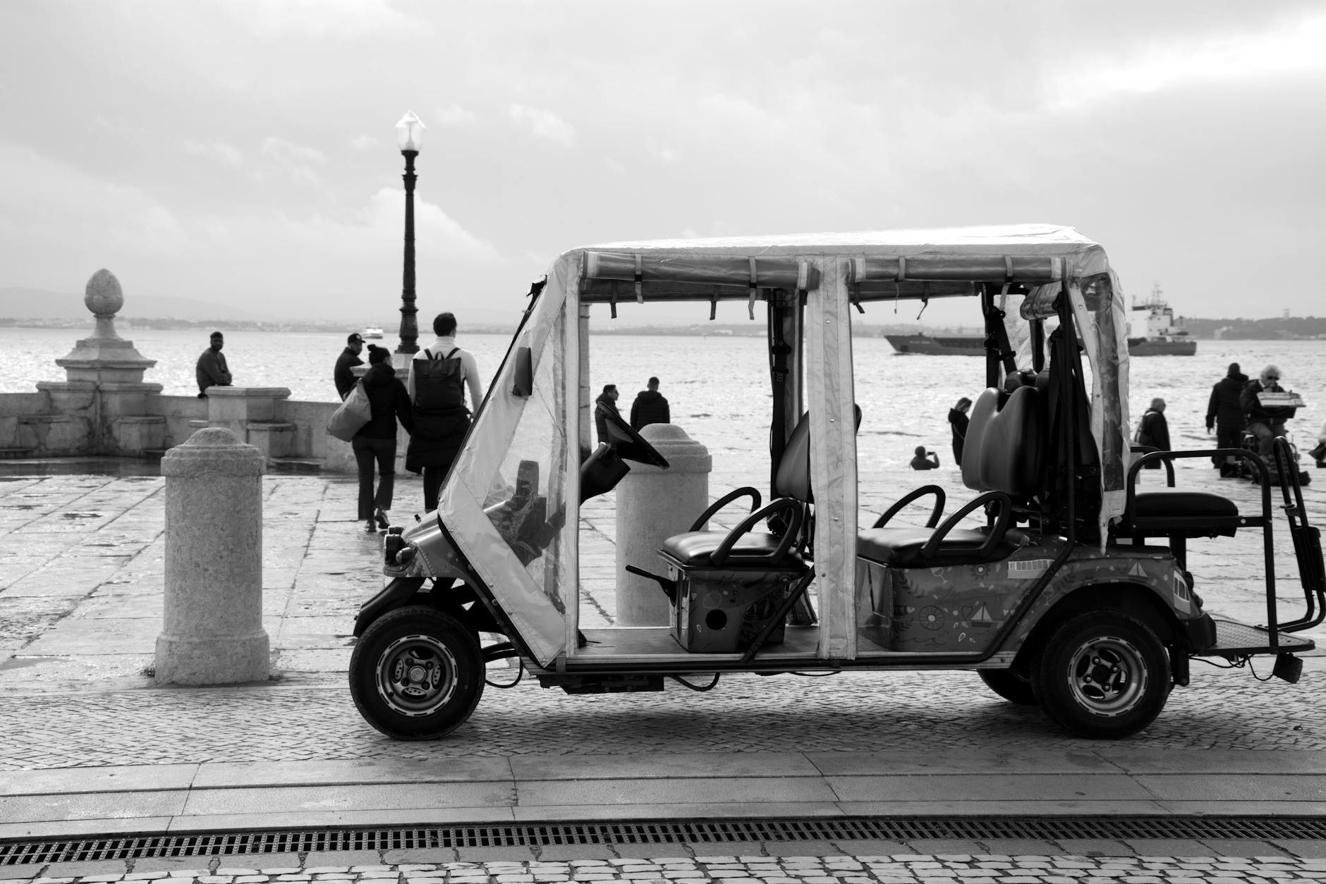 Colorful tuk-tuk tour vehicle on narrow streets in Lisbon