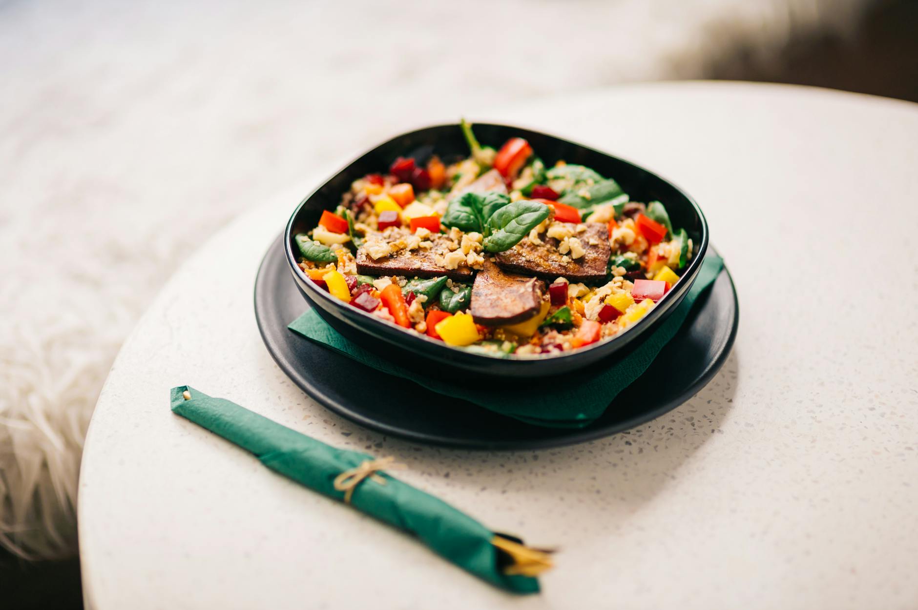 Colorful plant-based bowl with vegetables, grains, and tofu at a Lisbon vegan restaurant