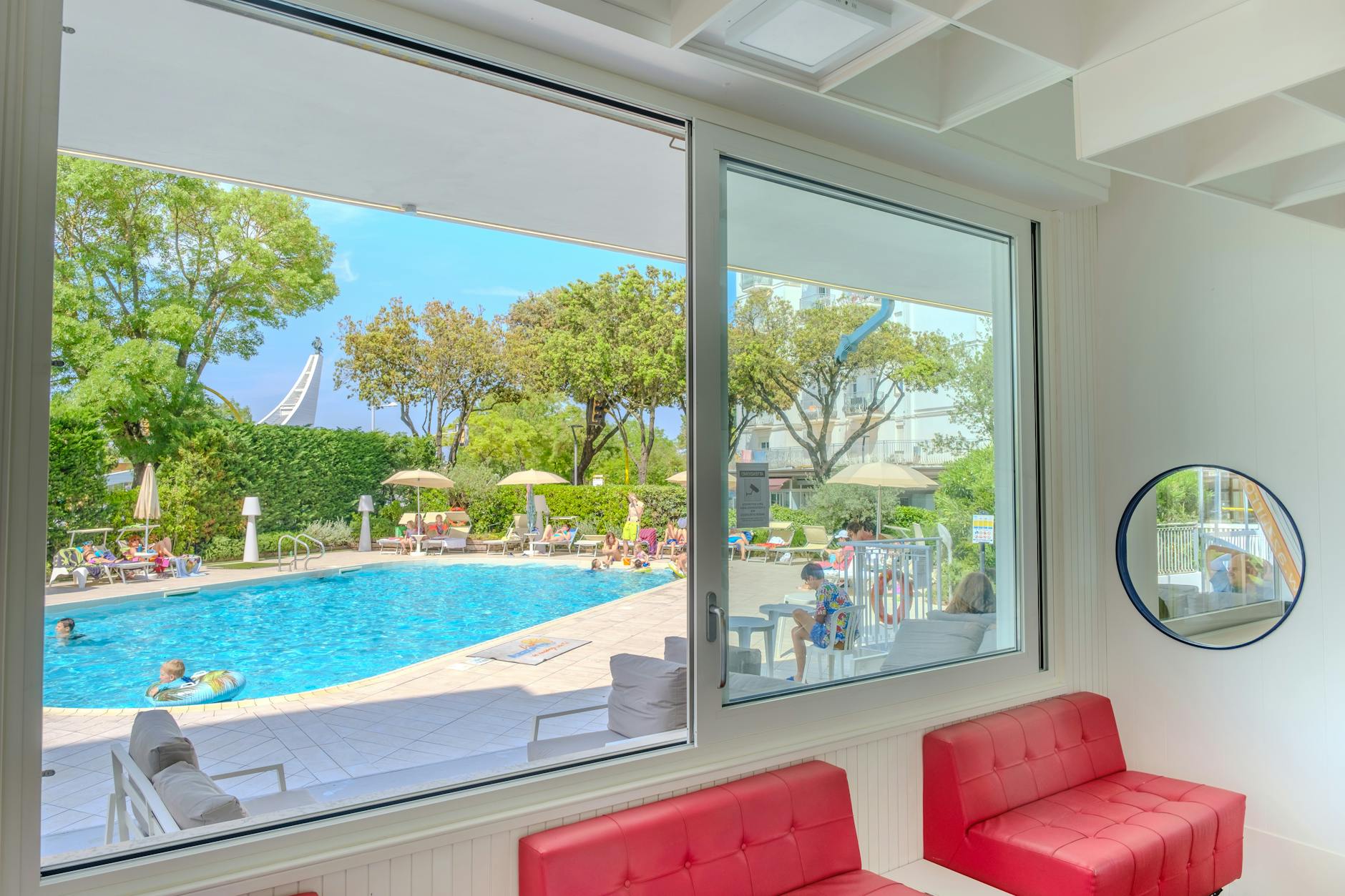 Family with children at a Lisbon hotel pool with city view