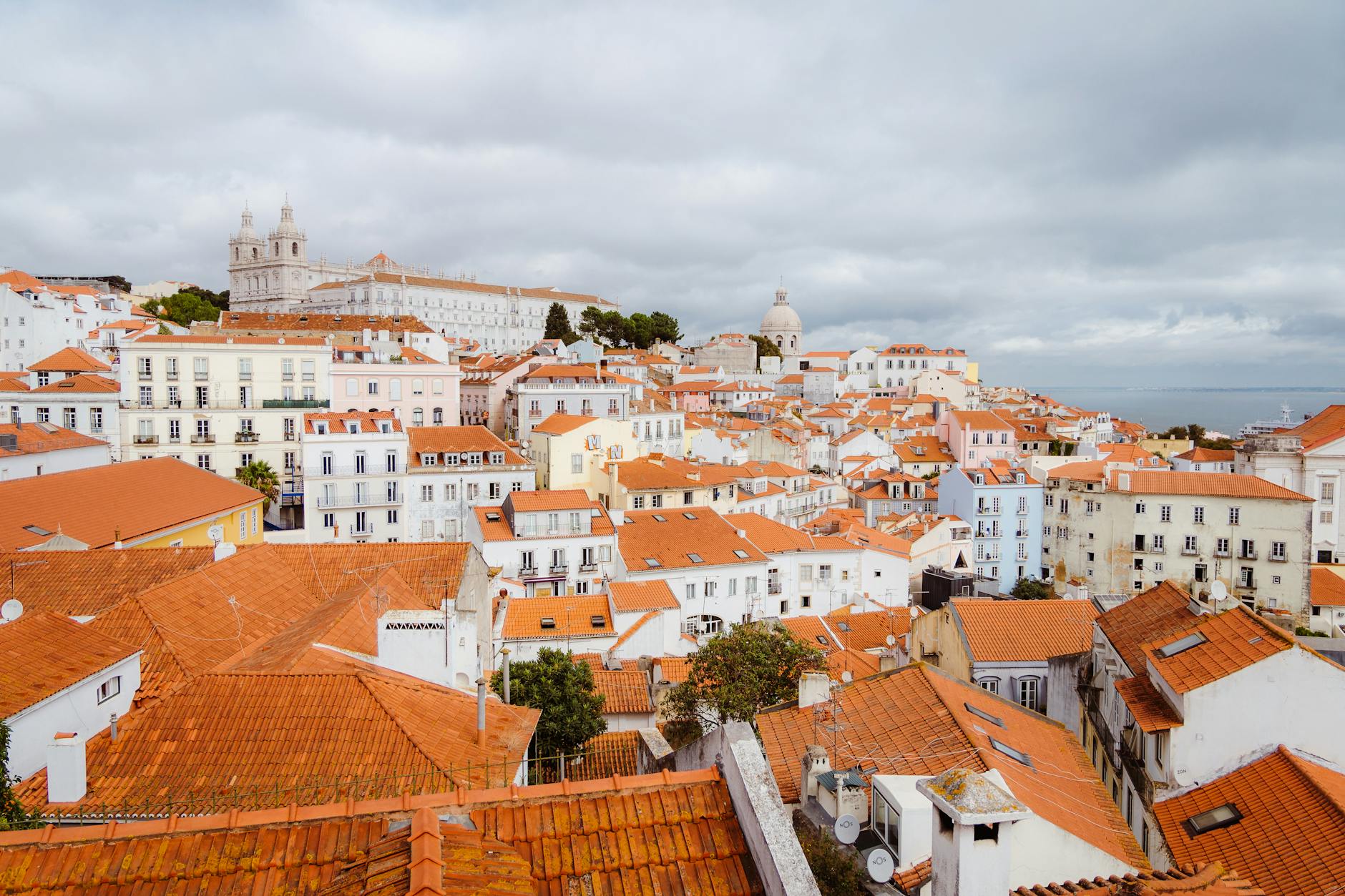 Red-tiled rooftops of Alfama district in Lisbon, Portugal — historic Moorish quarter above the Tagus River