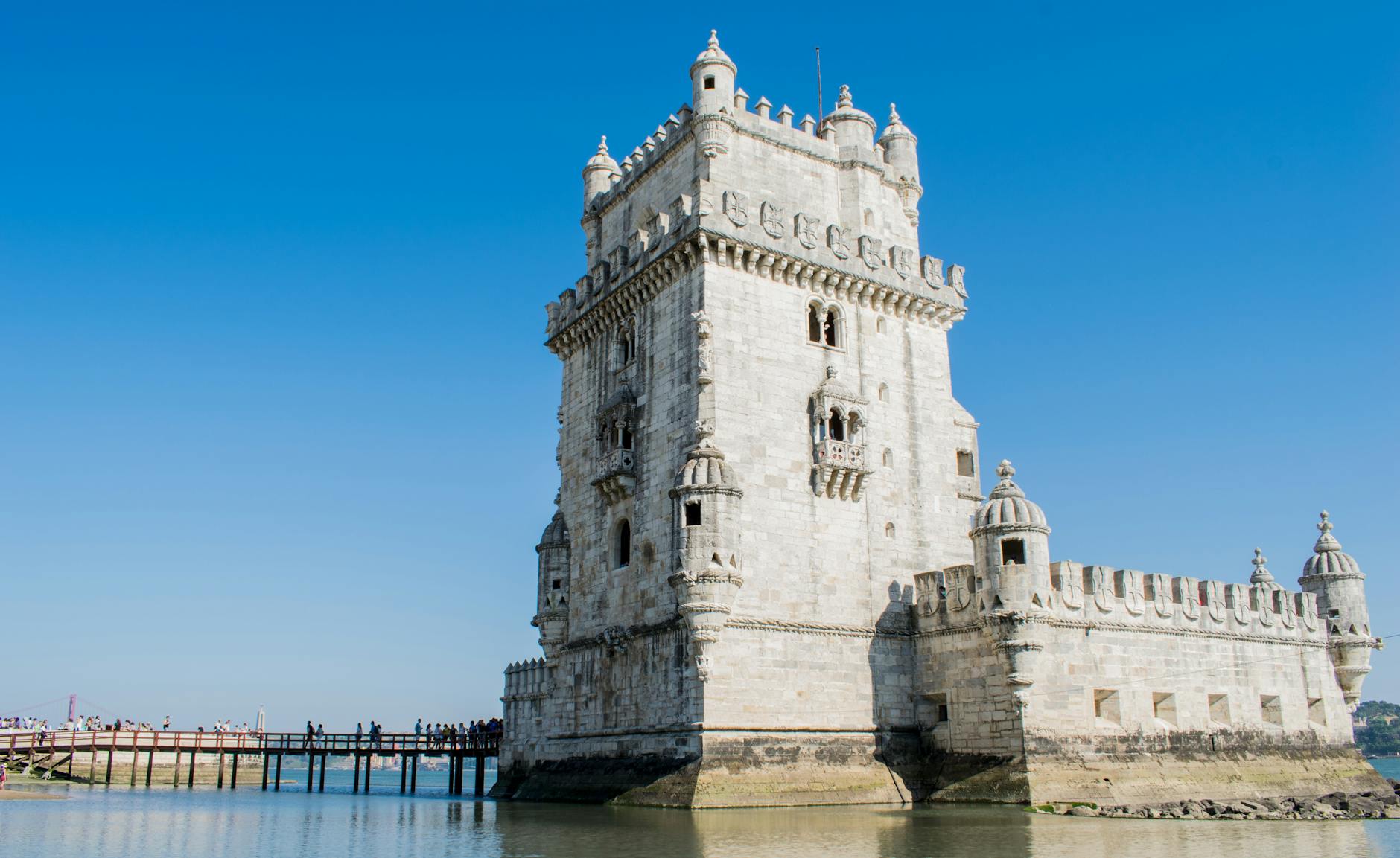Historic Belém Tower against a clear blue sky above the Tagus River, Lisbon Portugal