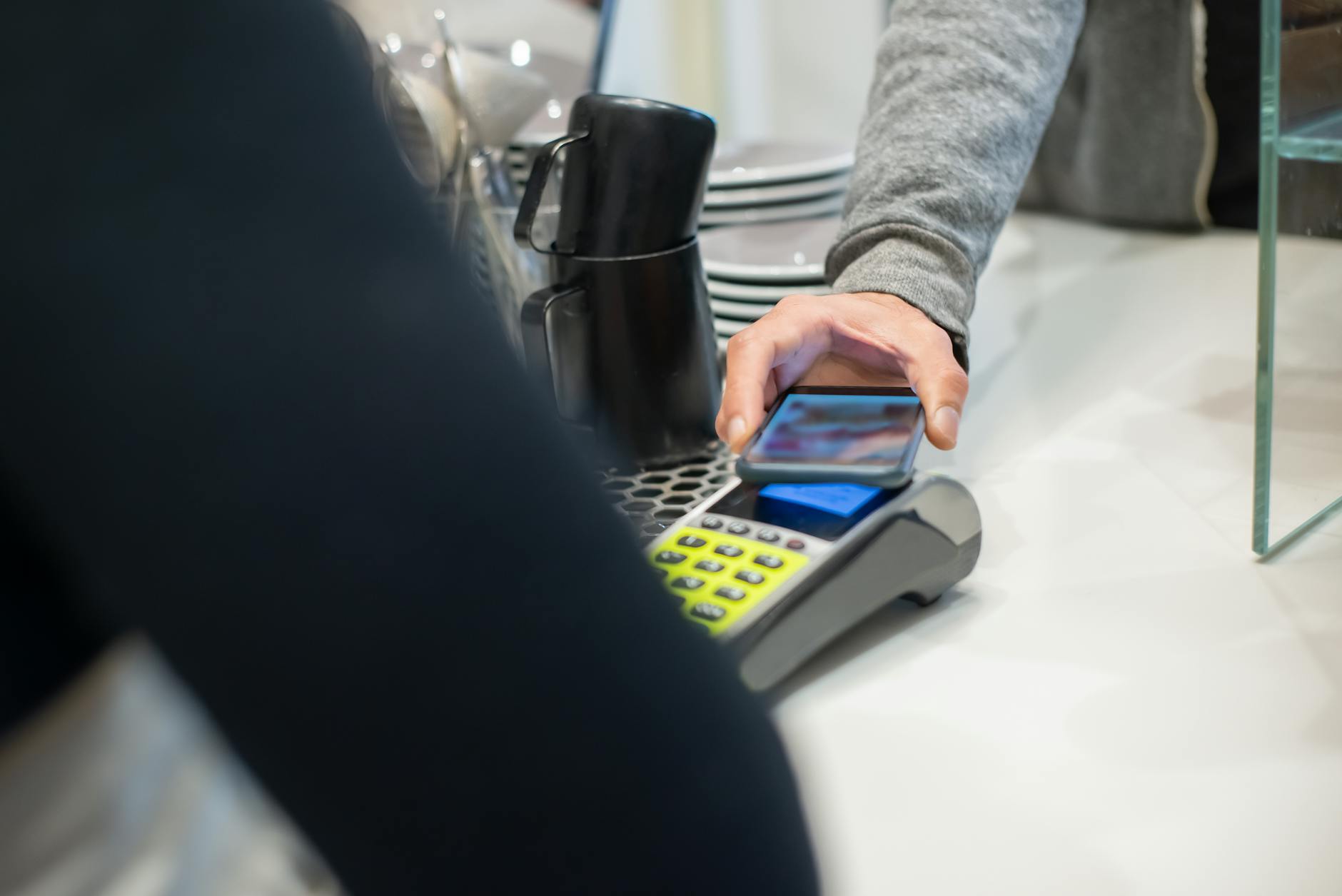 Contactless smartphone payment at a Lisbon cafe counter