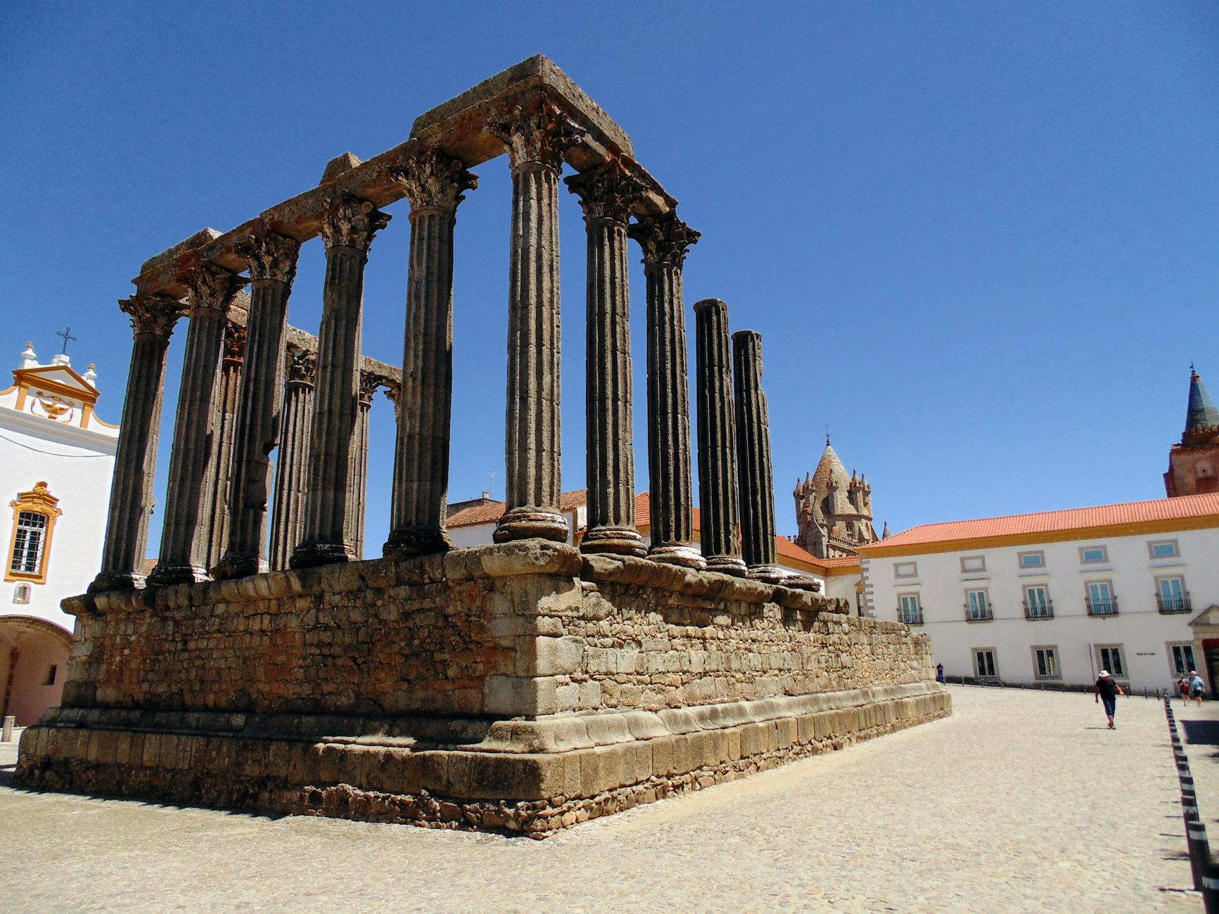 Ancient Roman temple ruins in Evora Portugal against vivid blue sky