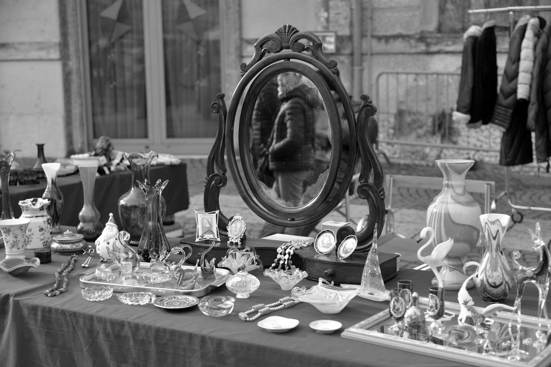 Outdoor antiques market stalls at Feira da Ladra Lisbon with vintage items on display