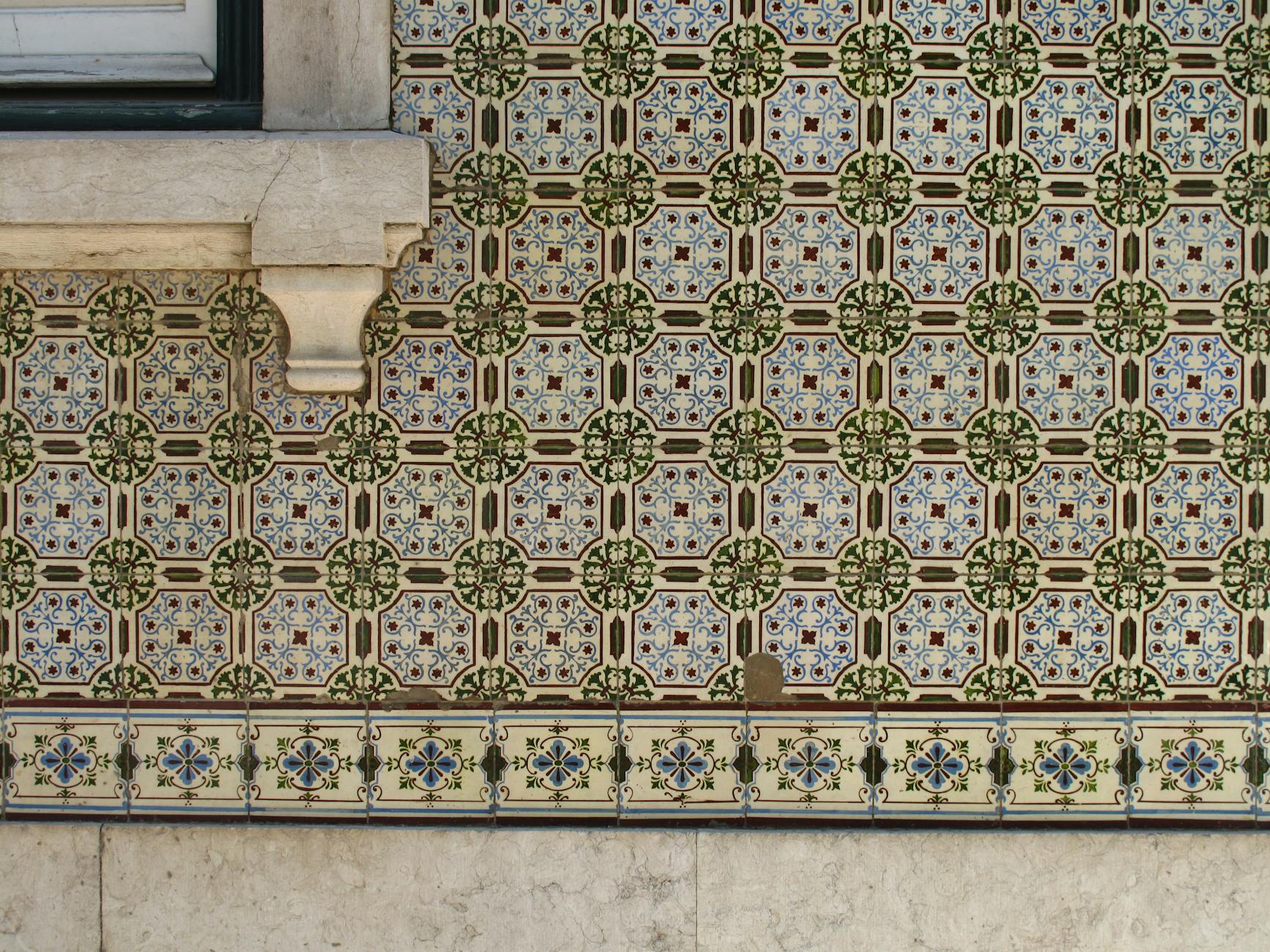 Intricate azulejo tile wall in Lisbon showing traditional Portuguese blue and white patterns