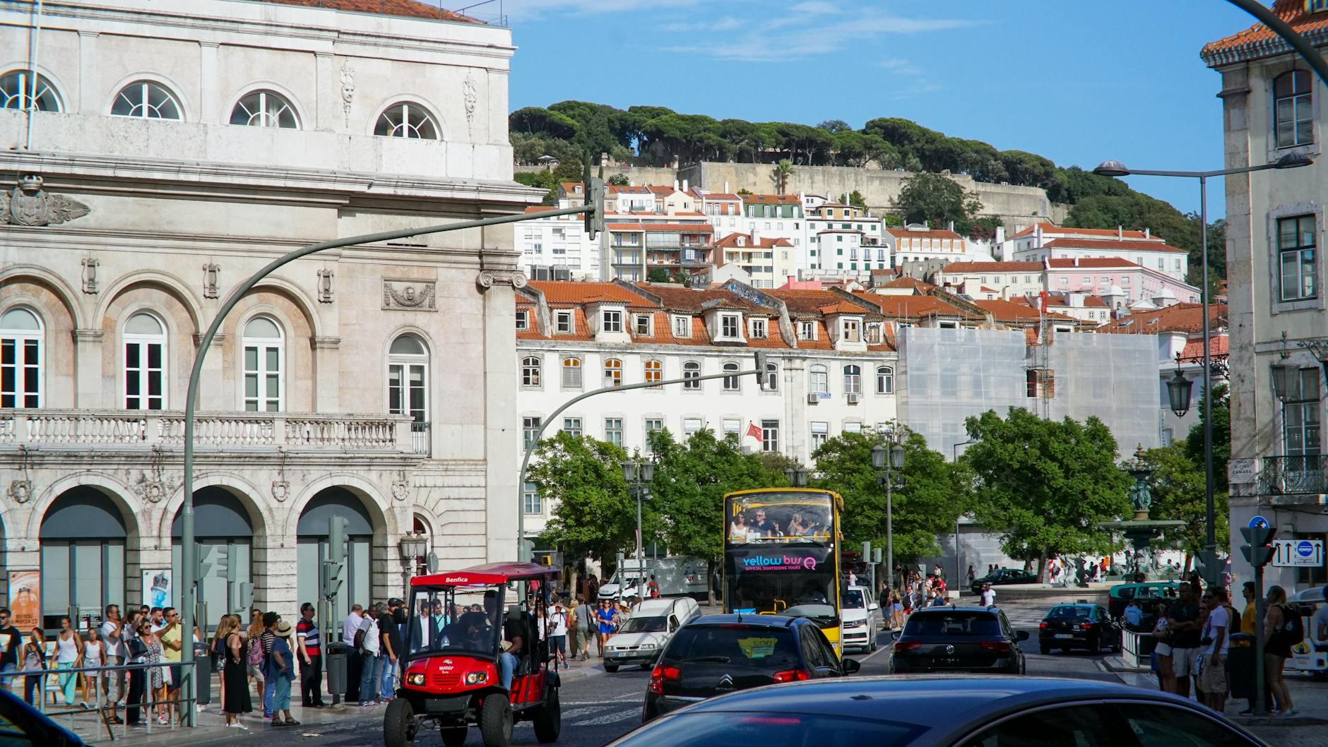Vibrant daytime view of central Lisbon with iconic architecture and busy street life