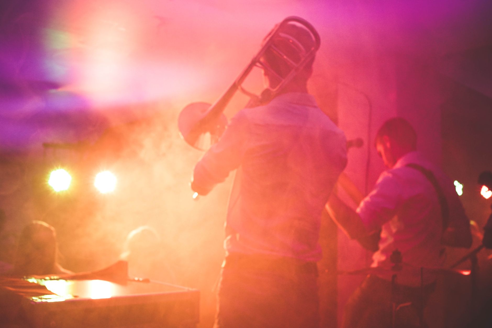 Live music band with trombone player performing on stage at Lisbon nightclub venue