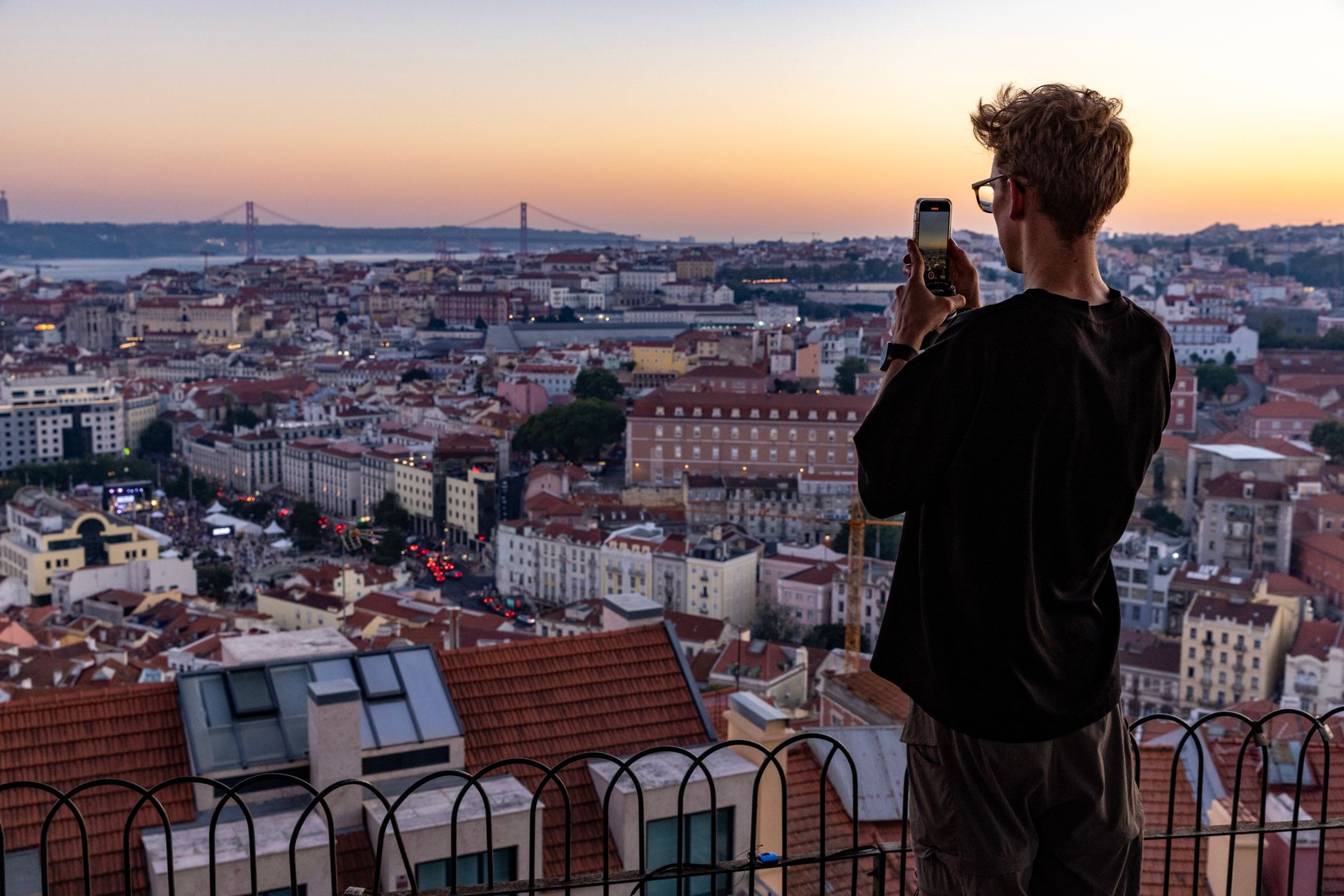 Lisbon cityscape viewed from a hilltop miradouro at sunset