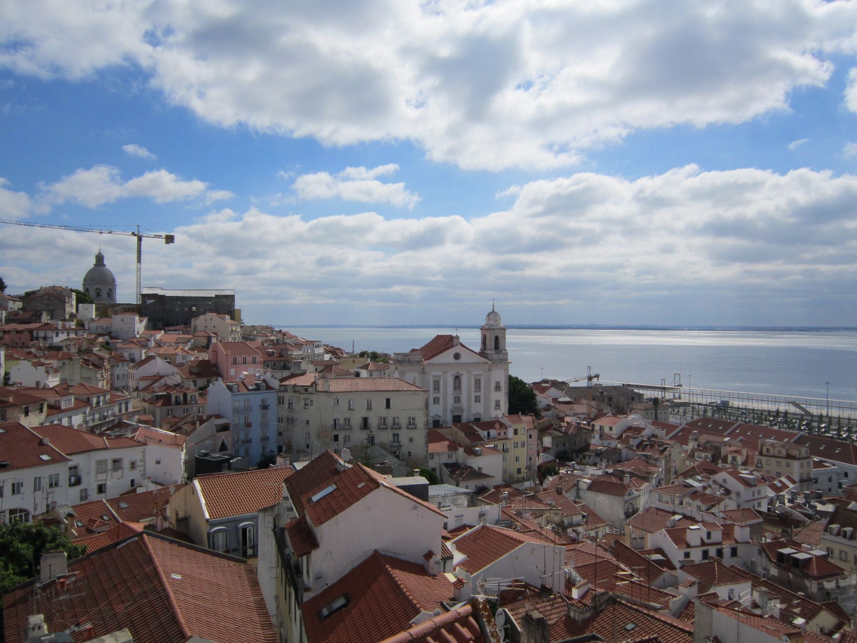 Rooftop view over Lisbon with church and Tagus River visible one day itinerary