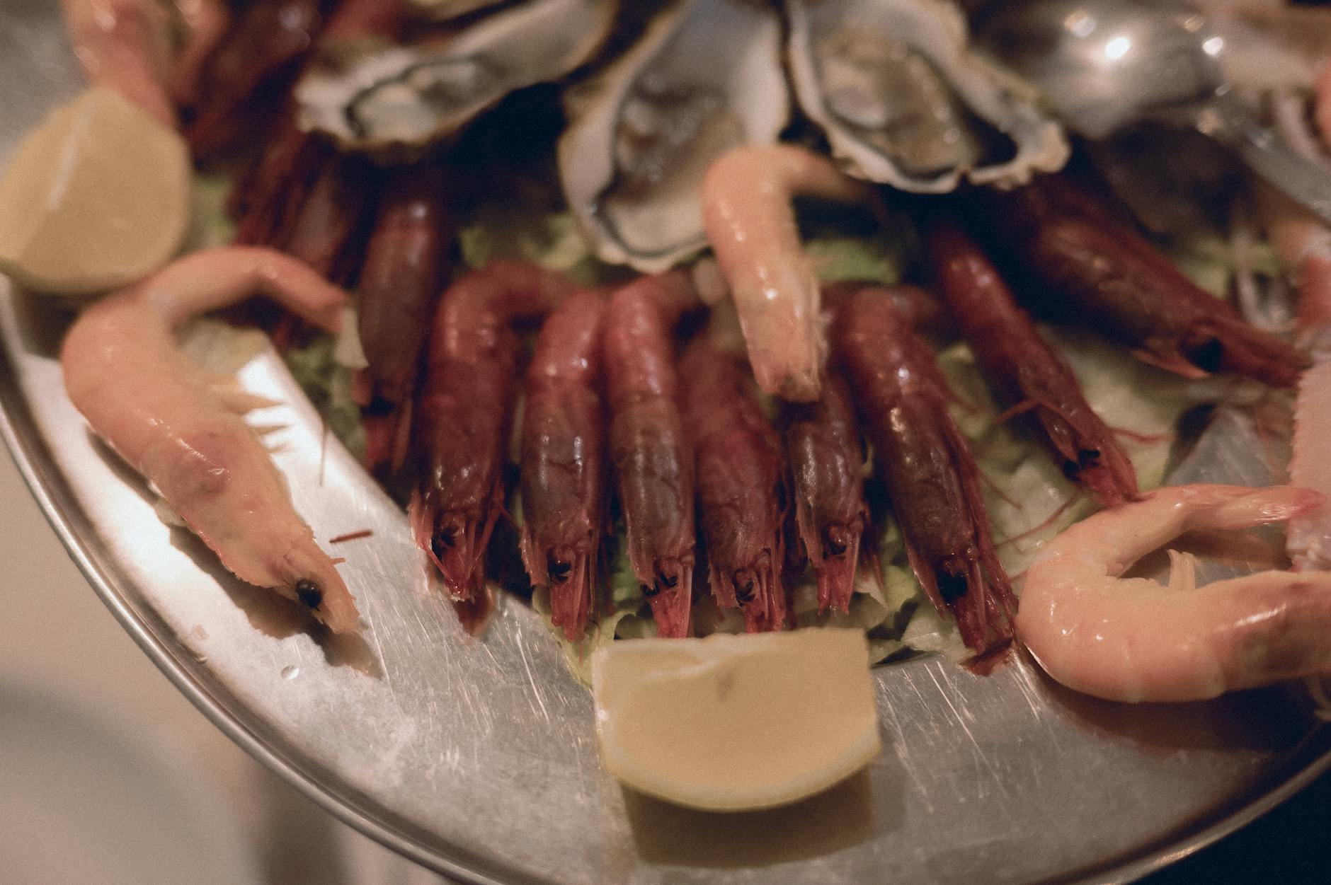 Seafood platter with fresh prawns oysters and lemon at a Lisbon marisqueira