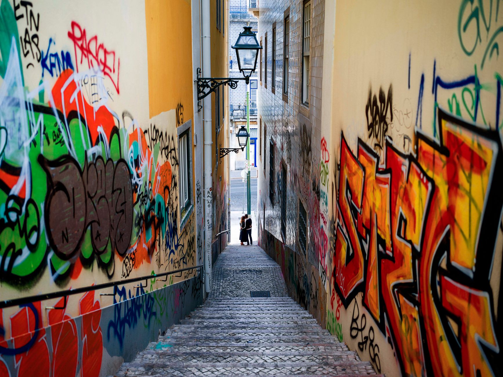 Vibrant street art graffiti in a narrow Lisbon alley off the tourist trail