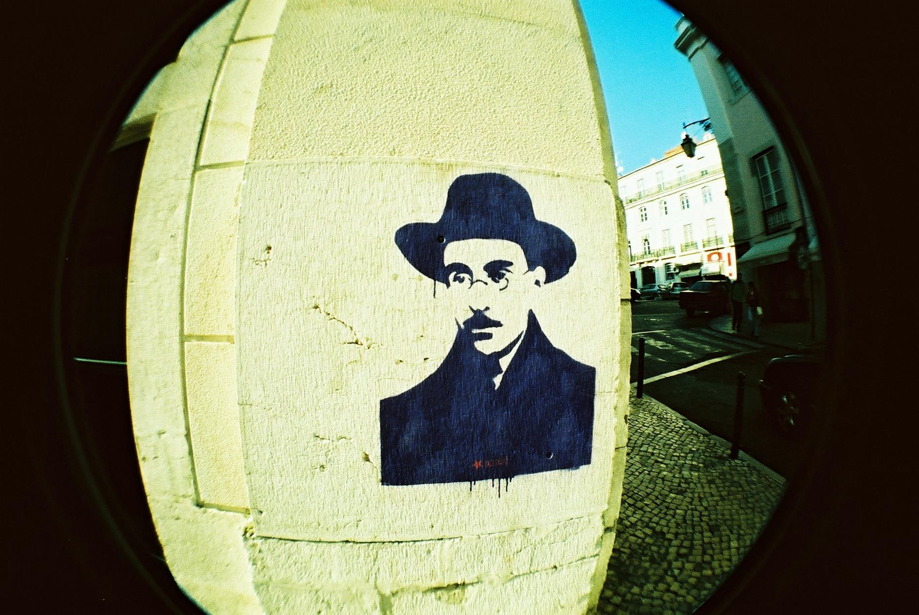 Street art portrait mural on a Lisbon building wall