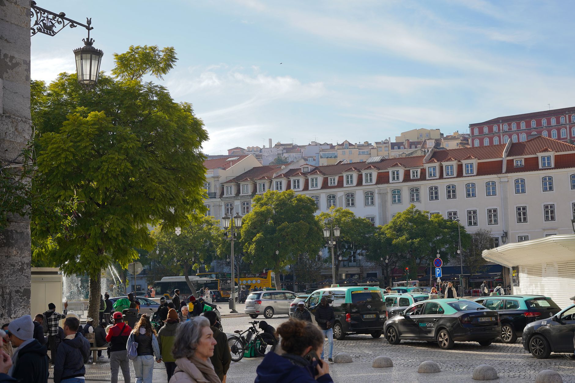 Busy daytime street in Lisbon city centre with European architecture and pedestrians