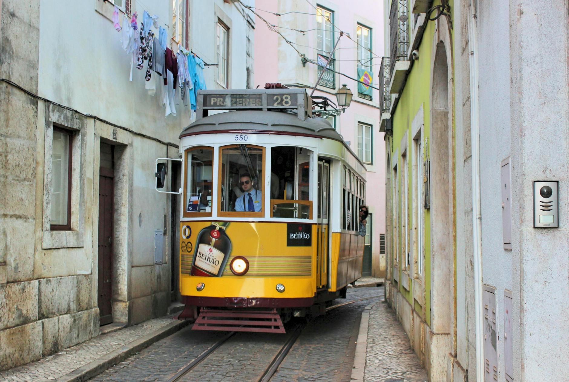 Tram 28 navigating the narrow cobblestone streets of Alfama on a Lisbon weekend break