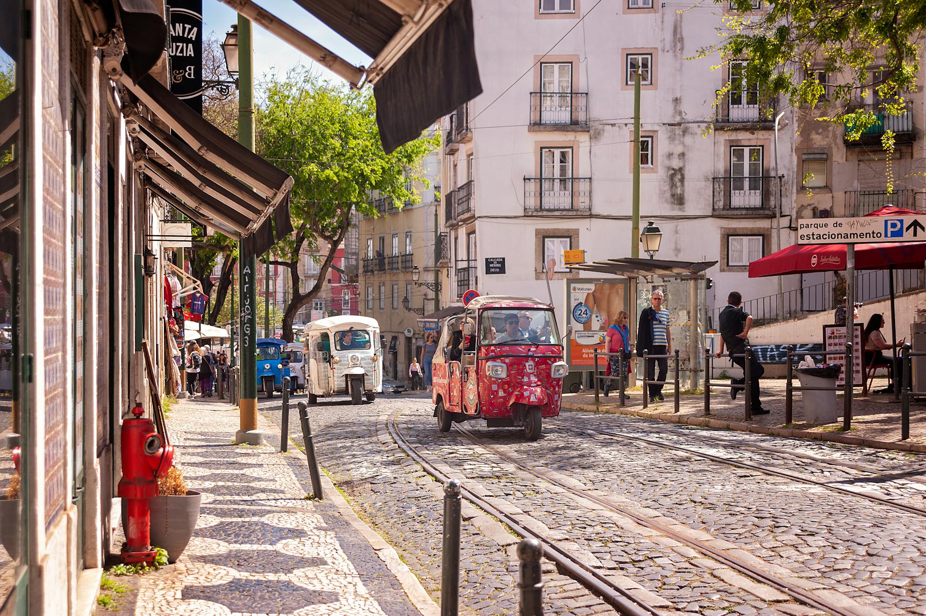 A tuk-tuk on a narrow Lisbon street in Alfama