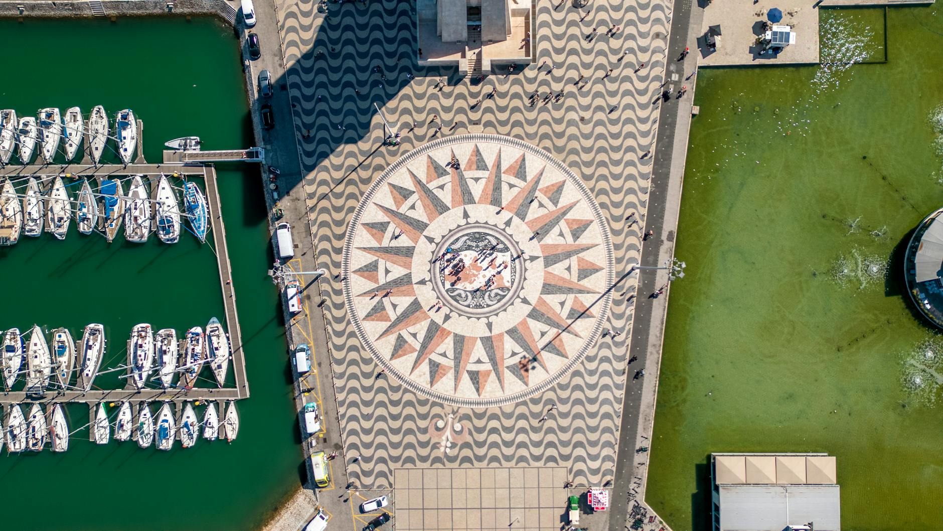 Aerial view of Padrão dos Descobrimentos monument and Belém waterfront from above