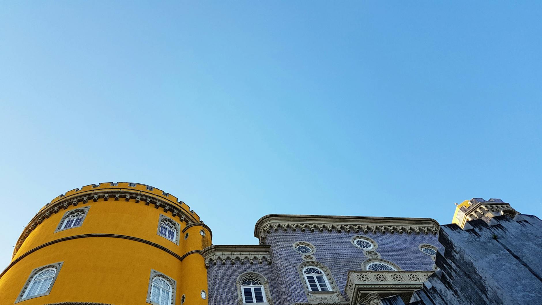 Colorful Pena Palace on hilltop in Sintra Portugal seen on day tour from Lisbon