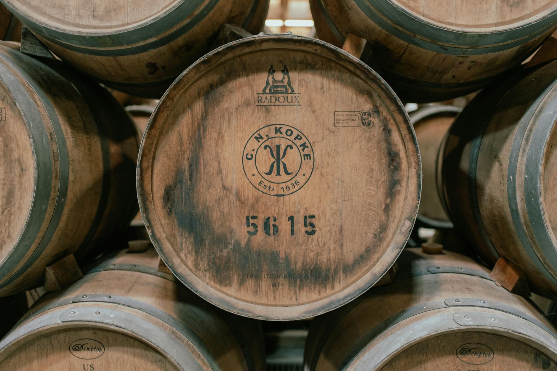Wooden wine barrels aging in a traditional Porto wine cellar in Vila Nova de Gaia