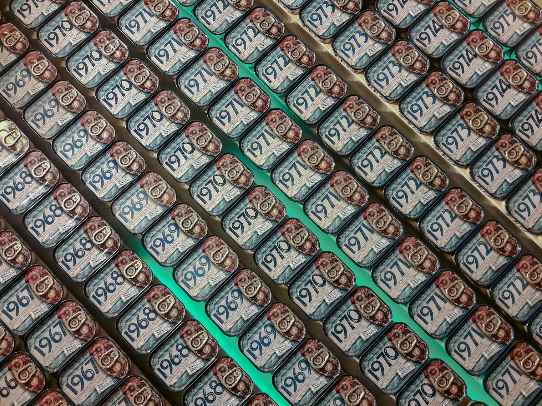 Rows of vintage Portuguese sardine cans on display showing various years