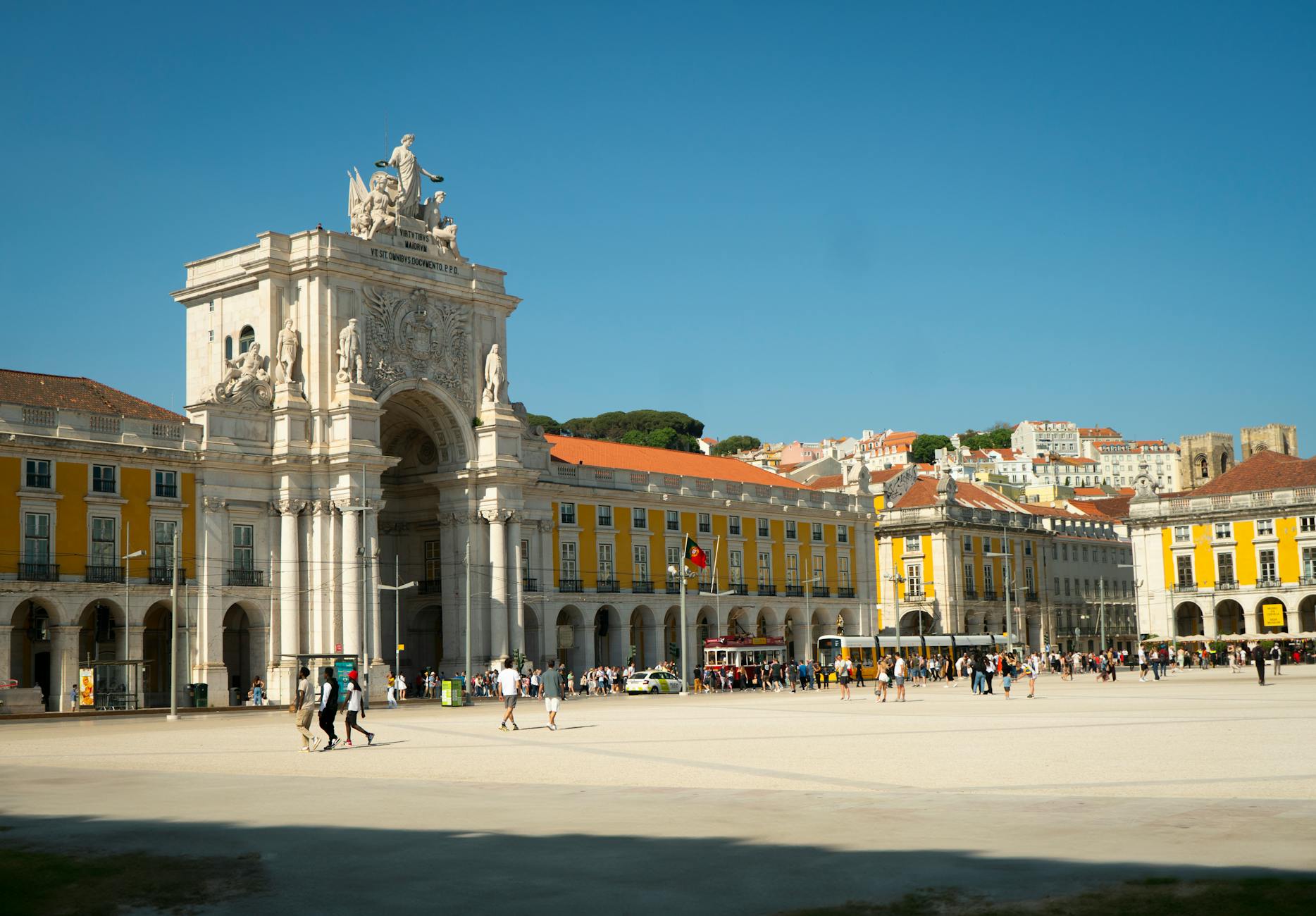 Praça do Comércio Lisbon equestrian statue and yellow neoclassical arcades with Tagus River in background