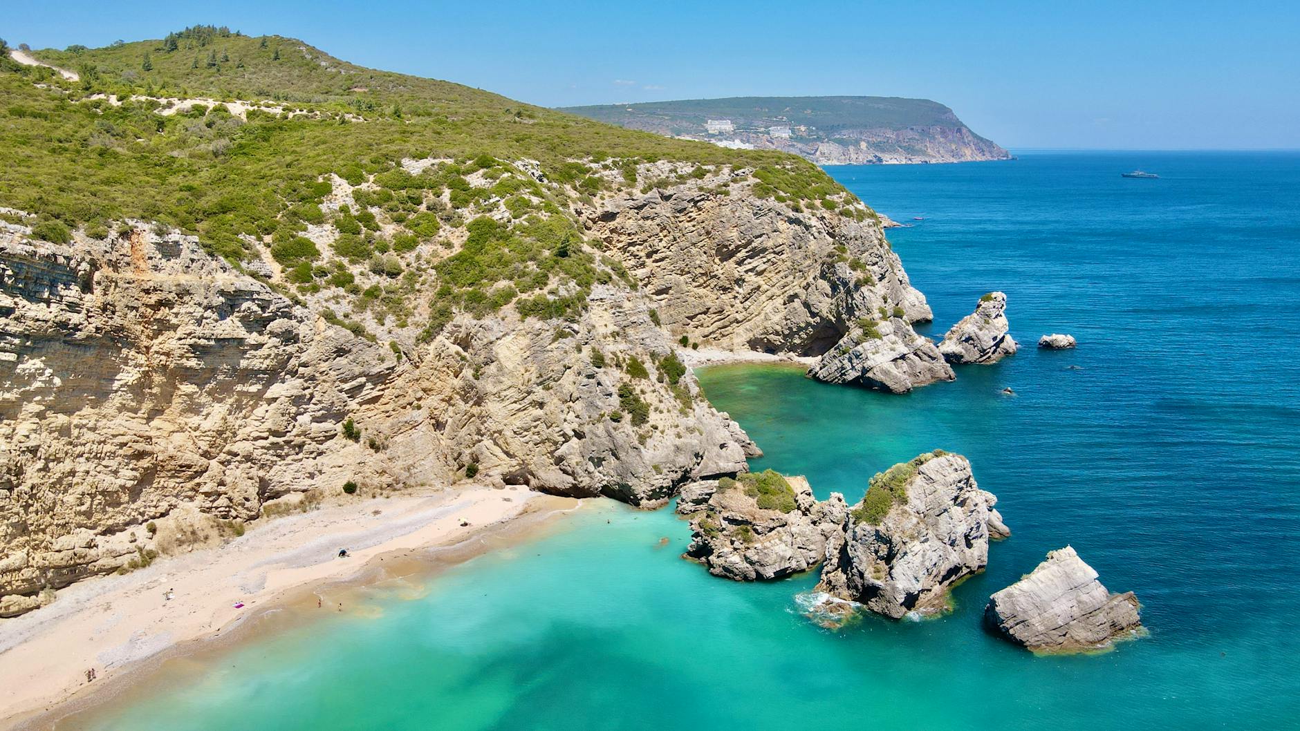 Praia do Ribeiro do Cavalo hidden cove turquoise waters Sesimbra Portugal