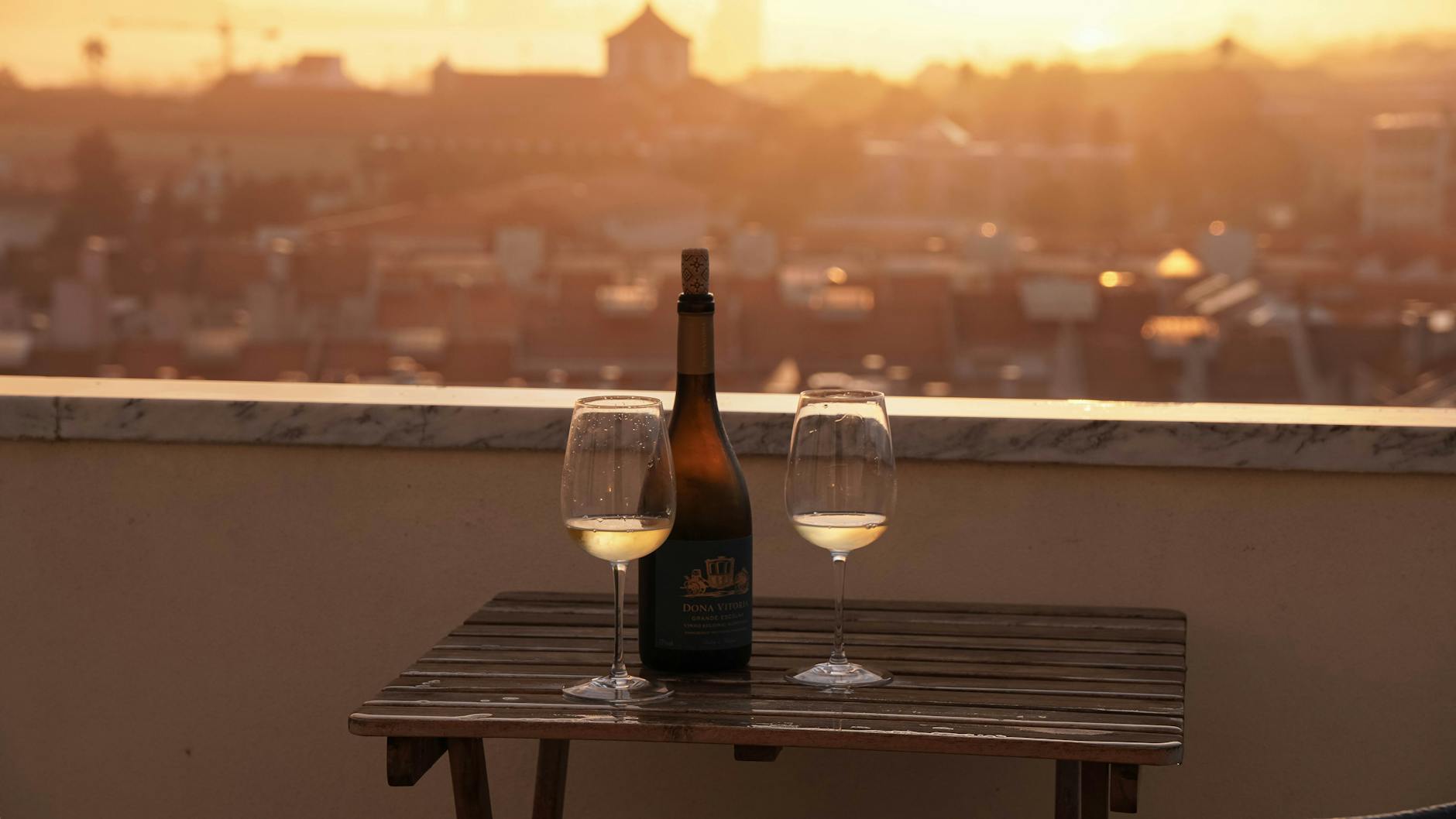 Wine tasting on a Lisbon rooftop terrace at sunset with city view