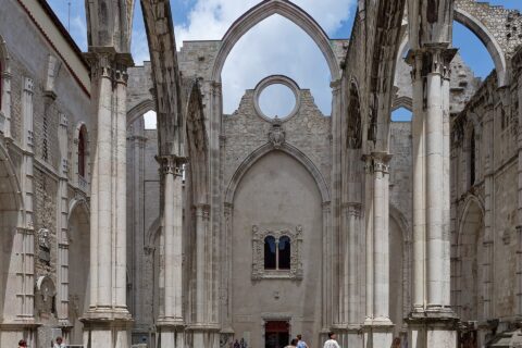 Roofless Gothic nave of the Carmo Convent in Lisbon with pointed arches open to the sky