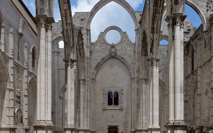 Roofless Gothic nave of the Carmo Convent in Lisbon with pointed arches open to the sky