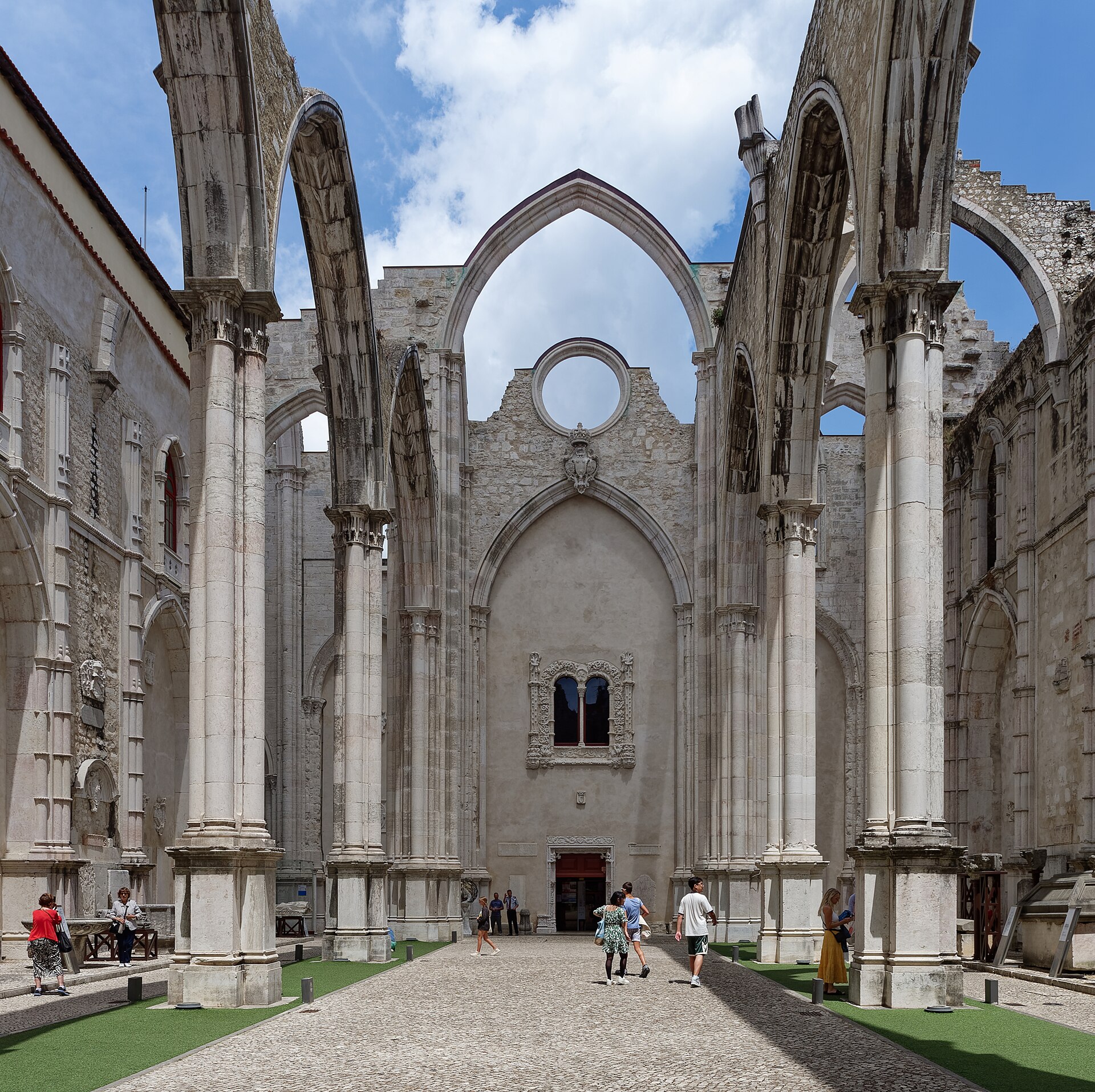 The roofless Gothic nave of the Carmo Convent in Lisbon with pointed arches open to the sky