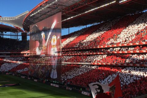 Packed red and white stands at the Estadio da Luz with a giant eagle tifo banner before a Benfica match
