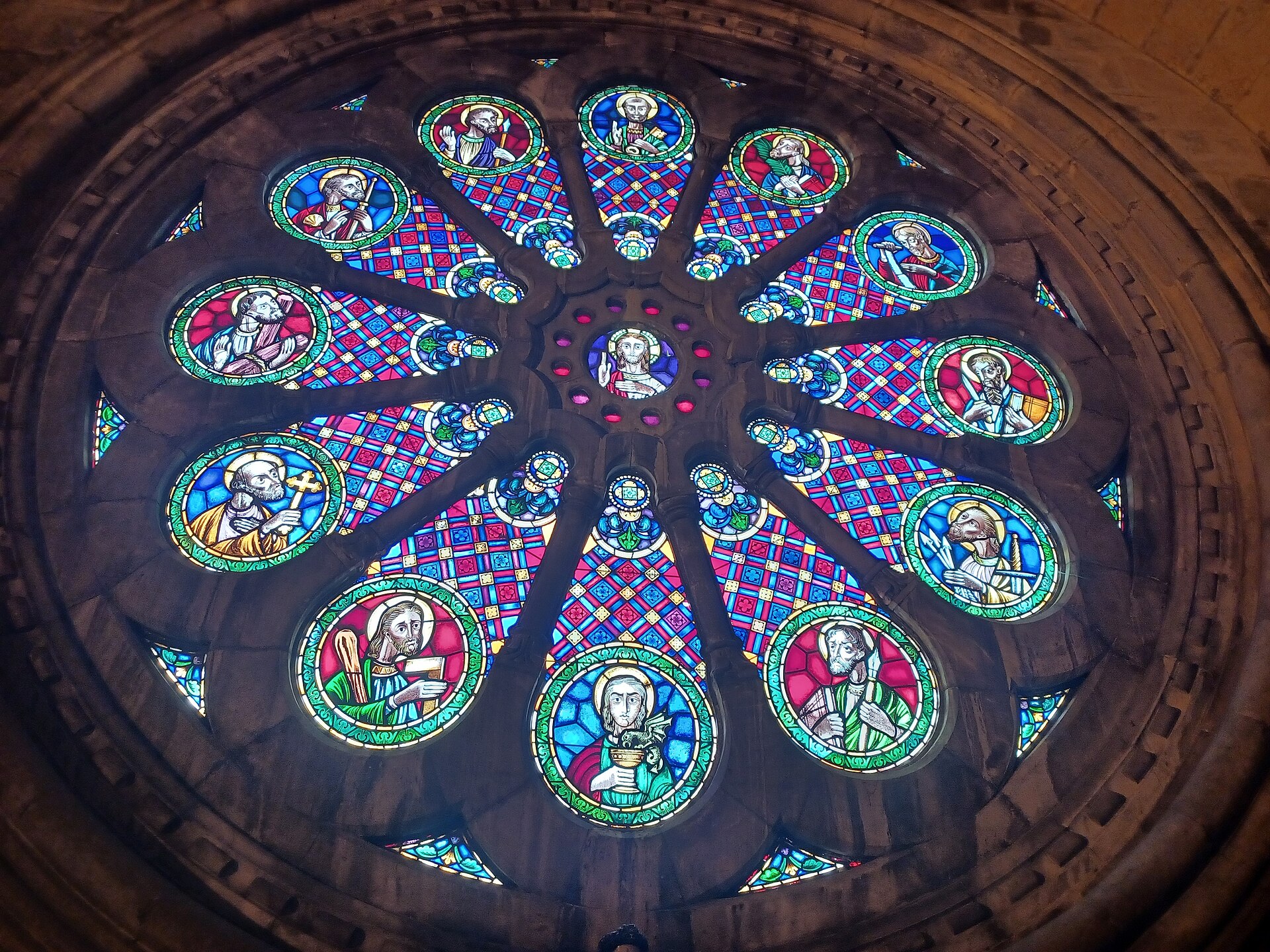 The rose window of Lisbon Cathedral seen from inside, with the twelve apostles in stained glass