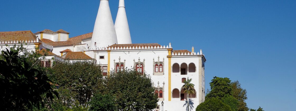 The National Palace of Sintra with its two enormous white conical kitchen chimneys rising above the town rooftops