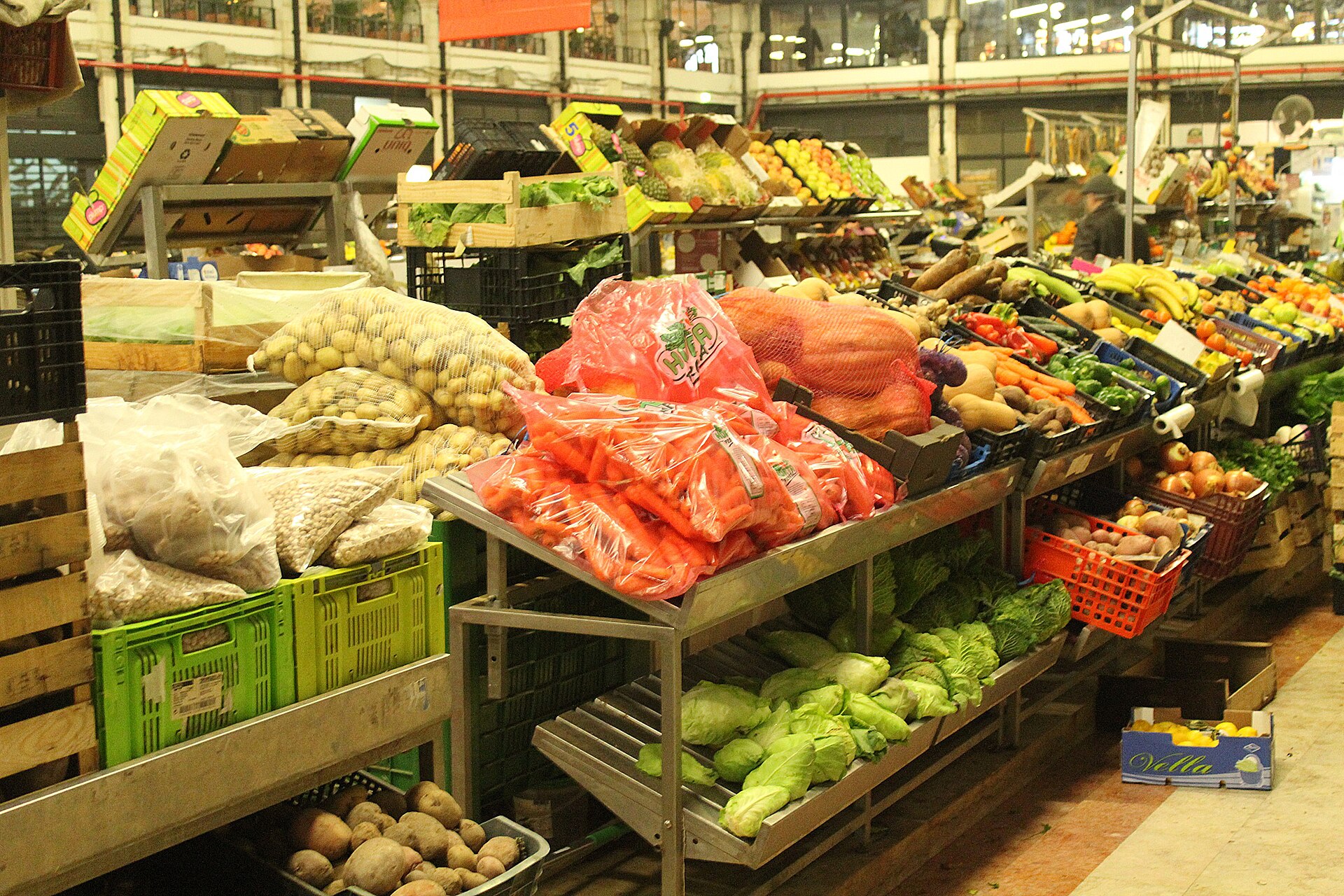Carrots, potatoes, cabbages and other fresh produce fill a stall inside Lisbon’s Mercado da Ribeira.