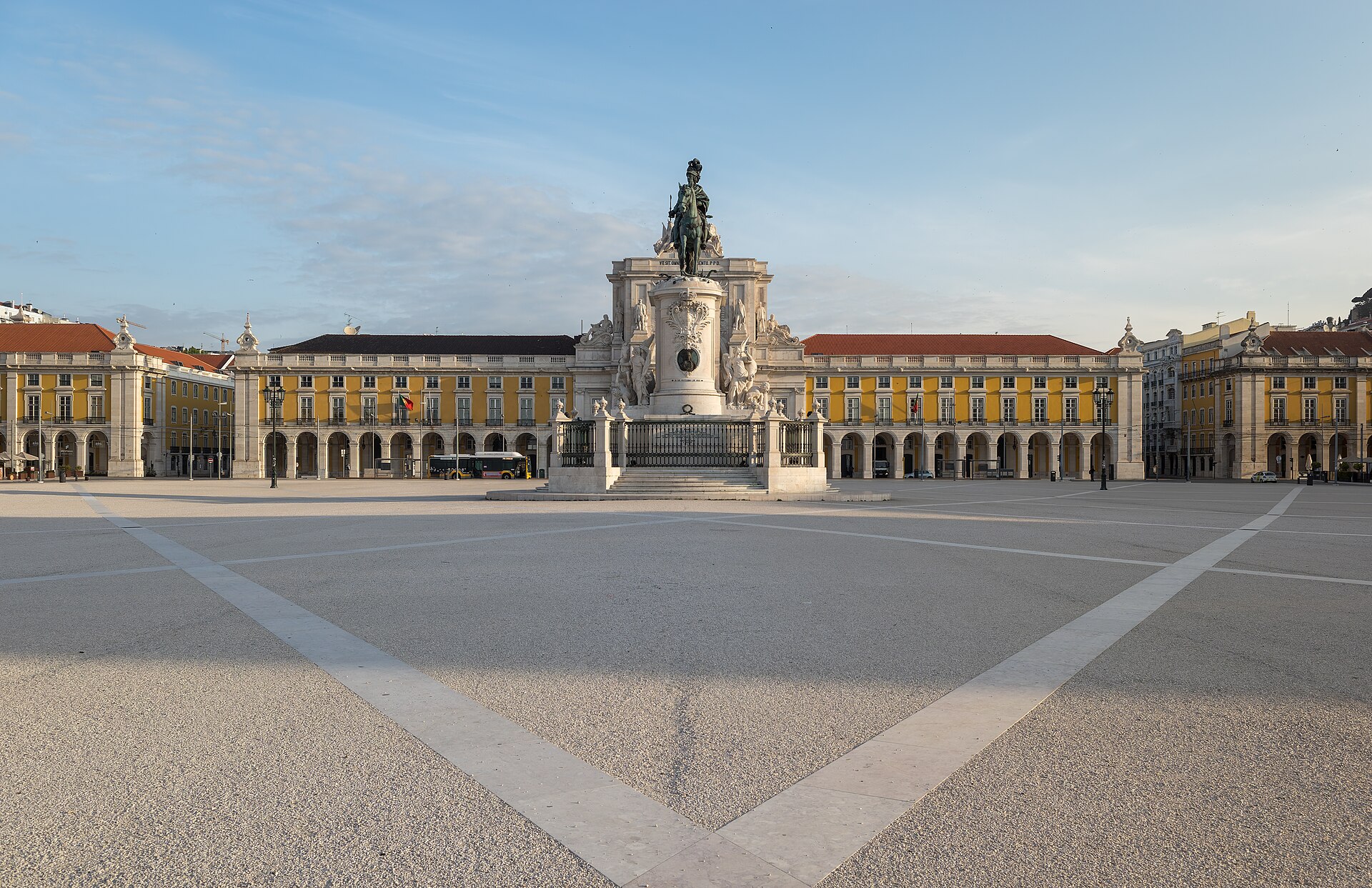 King José I’s statue aligns with the Rua Augusta Arch across an empty Praça do Comércio in Lisbon’s morning light.