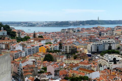 São Jorge Castle overlooks Lisbon’s red rooftops, with the Tagus River, Cristo Rei and 25 de Abril Bridge beyond.